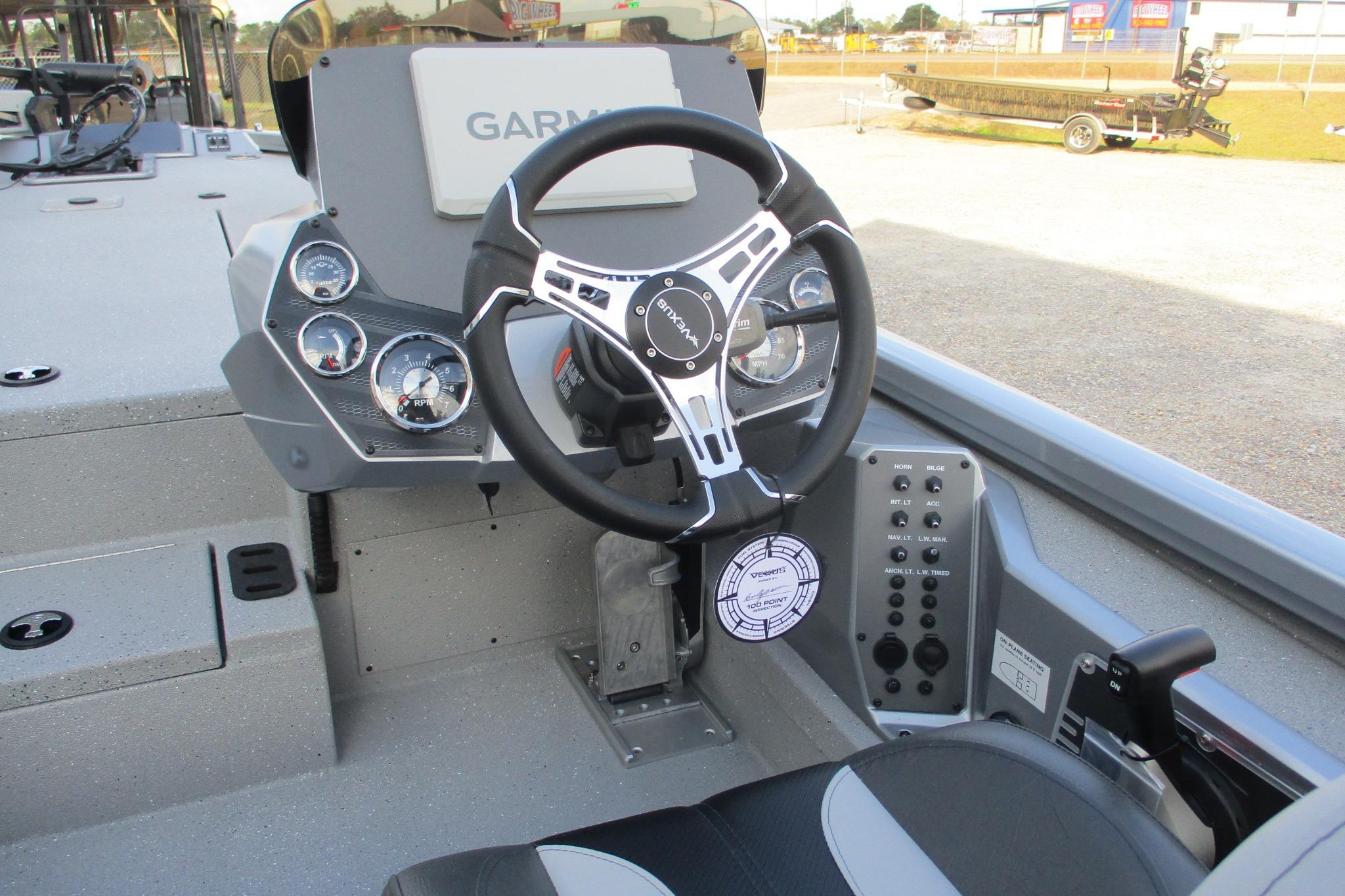 2026 Vexus AVX2080 boat dashboard with Garmin display and steering wheel.