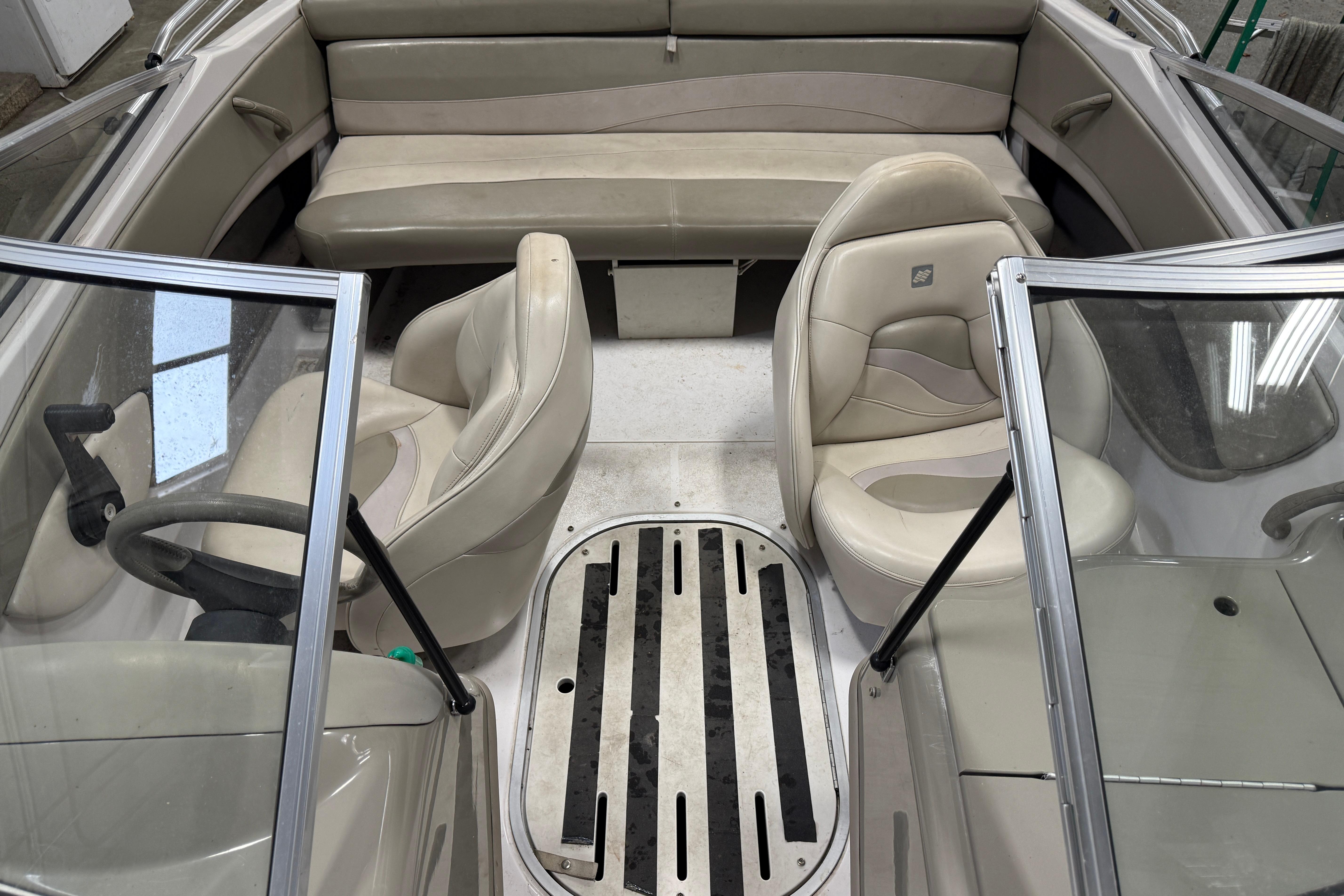 1999 Four Winns 170 Horizon LE boat interior with beige seating and steering wheel.