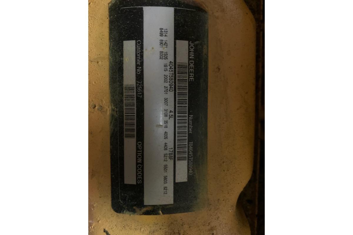 ```json { "alt_text": "John Deere label with serial number on Morgan Out Island 51, 1977." } ```