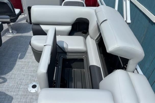 2026 Sun Tracker SportFish 20 DLX boat interior with gray cushioned seating and storage compartments.