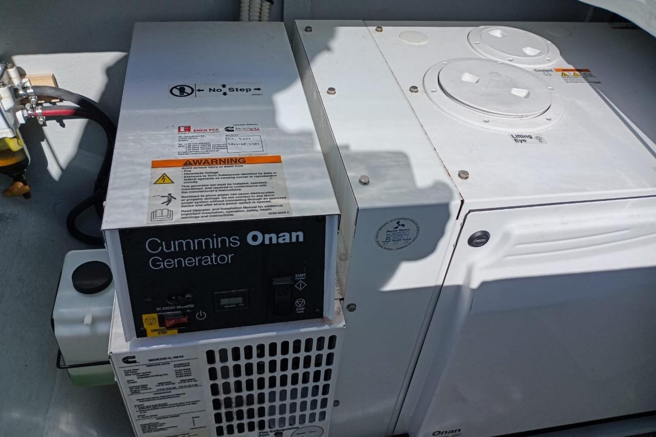 Cummins Onan generator on a 2020 Lagoon 450 F yacht, featuring safety warnings and controls.