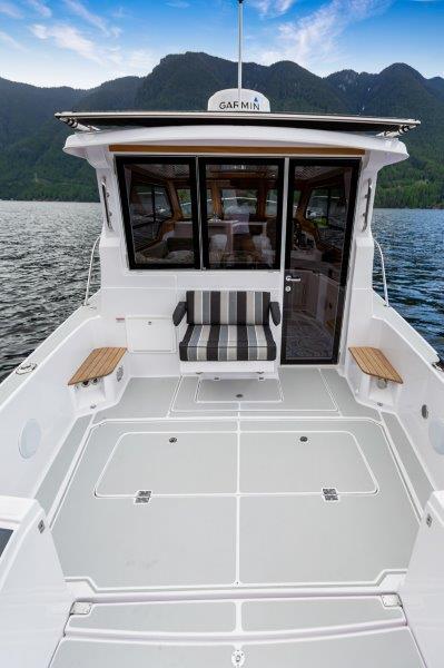 2024 True North 34 boat with spacious deck and scenic mountain backdrop.