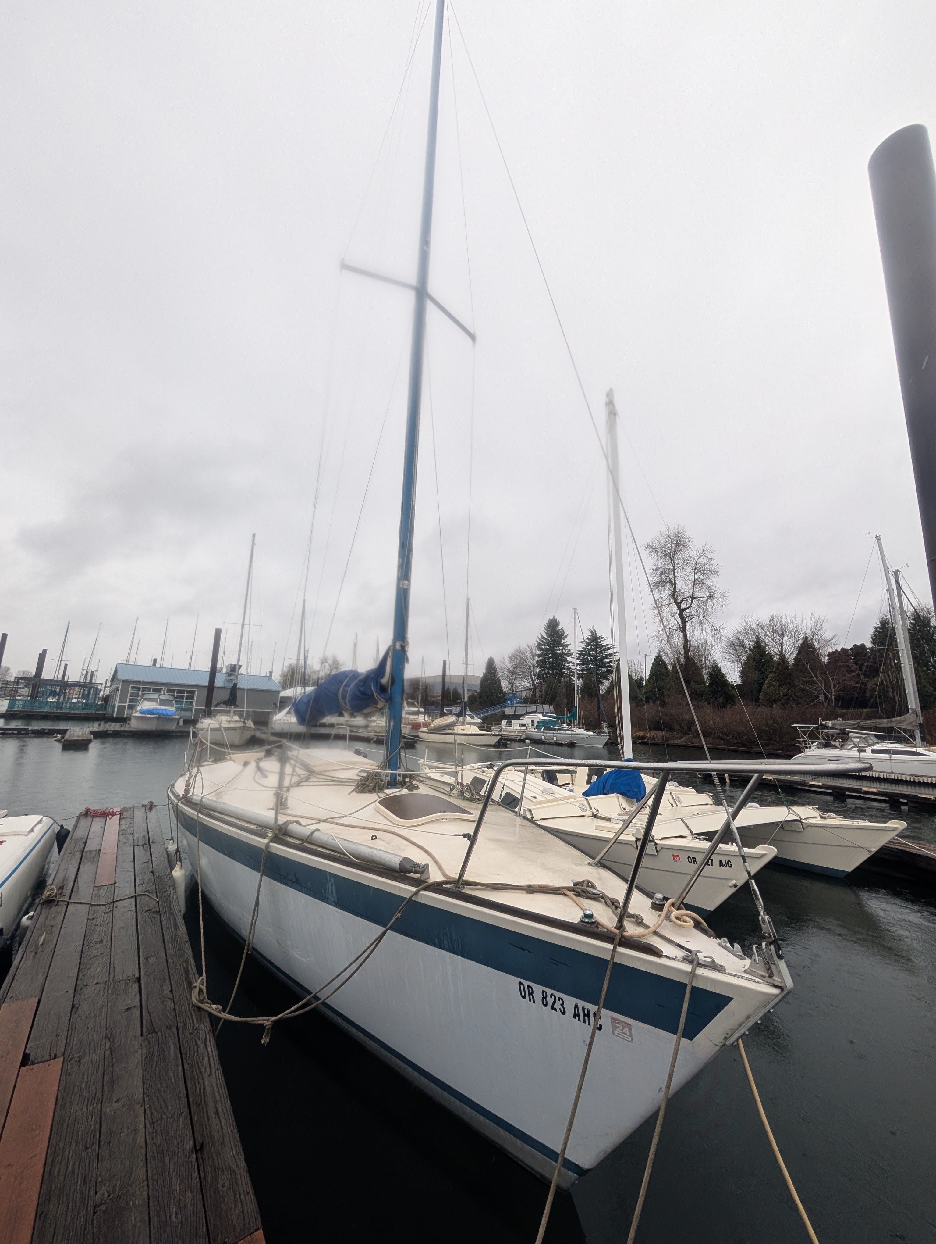 A 1981 Pearson Flyer 30 is docked. The sky is overcast.