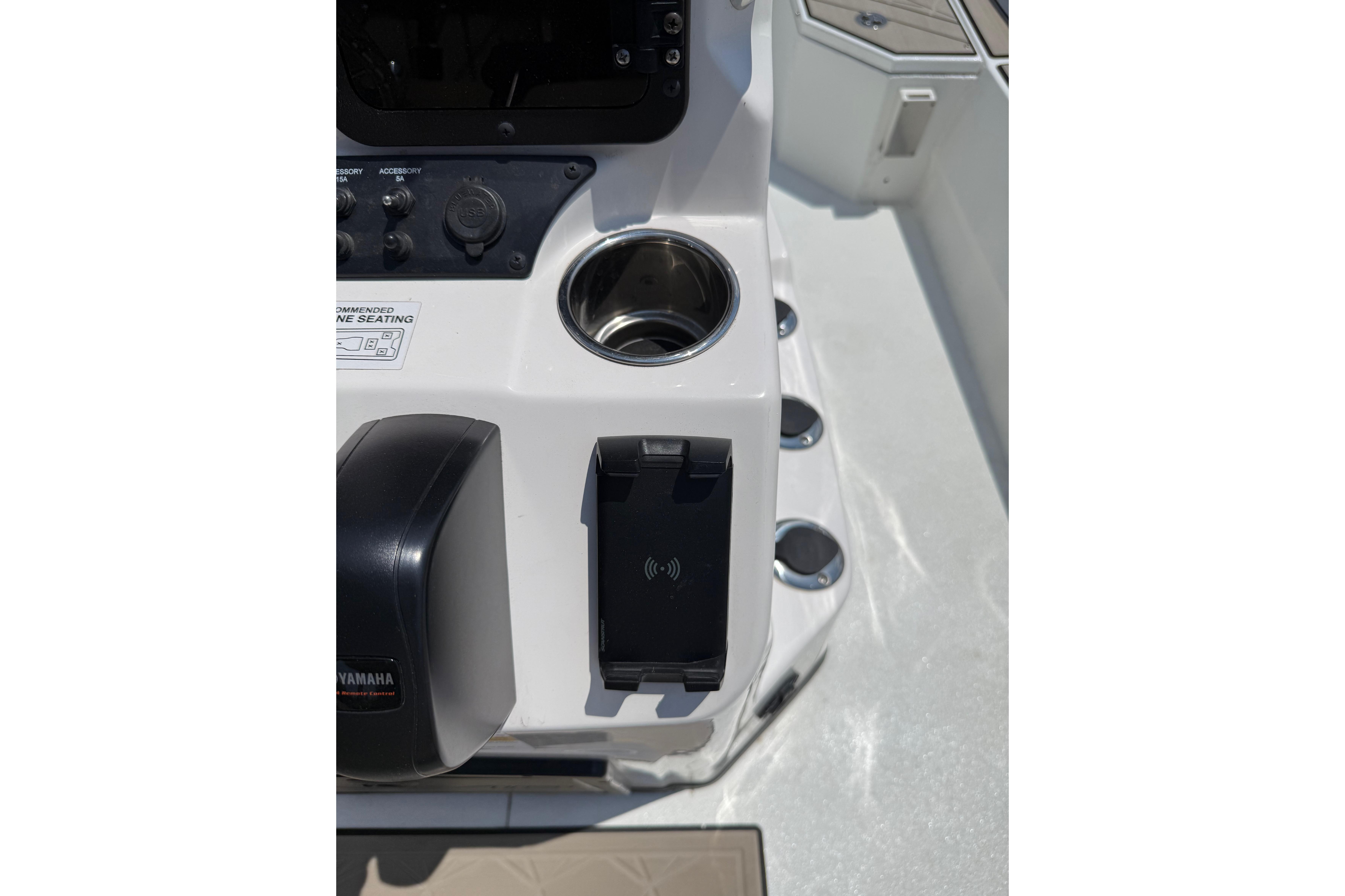 Control panel of 2025 Avid 22 Recon boat with cup holder and phone mount.
