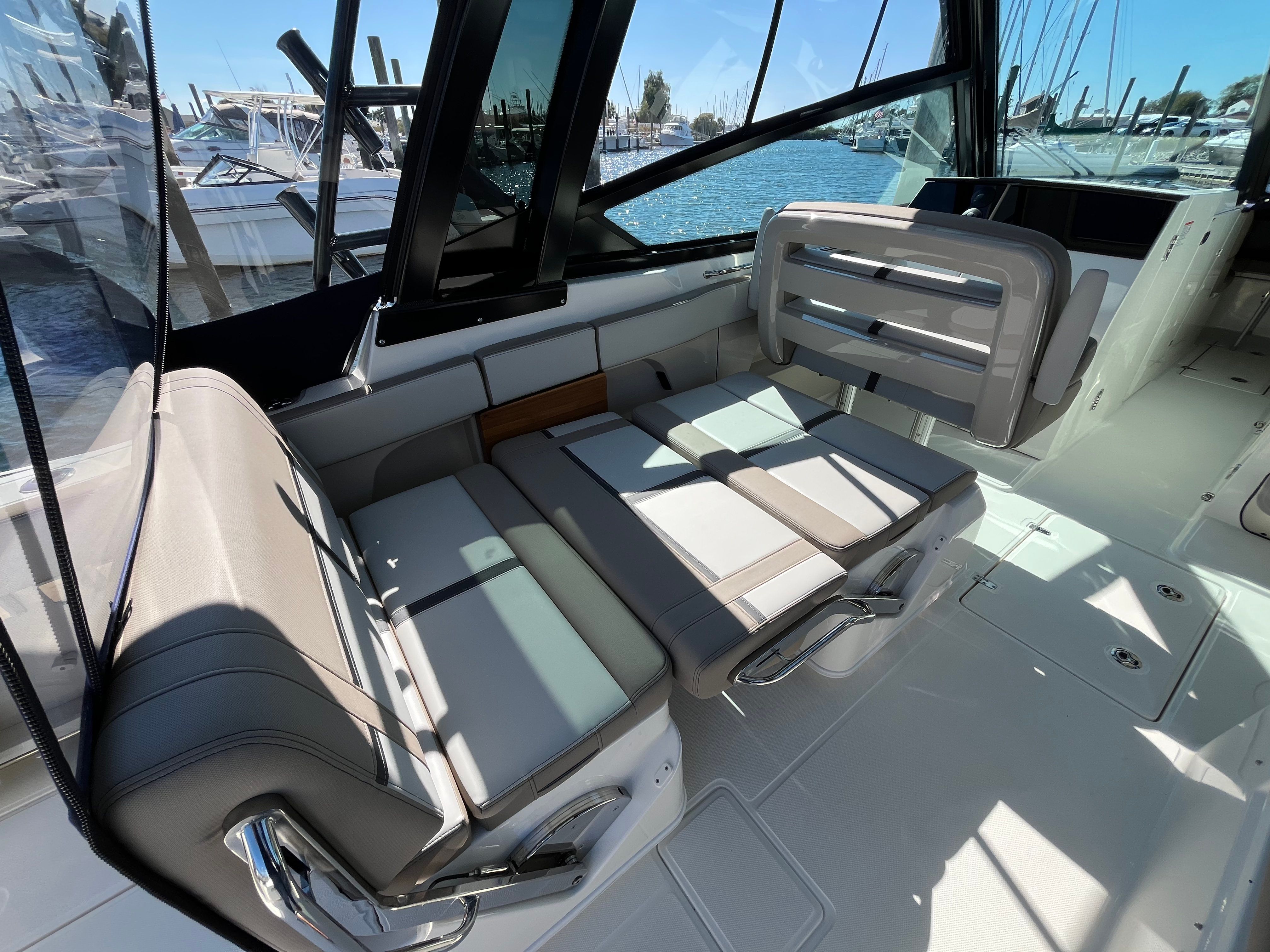 The 2025 Boston Whaler 330 Vantage features a luxurious seating area overlooking the marina.