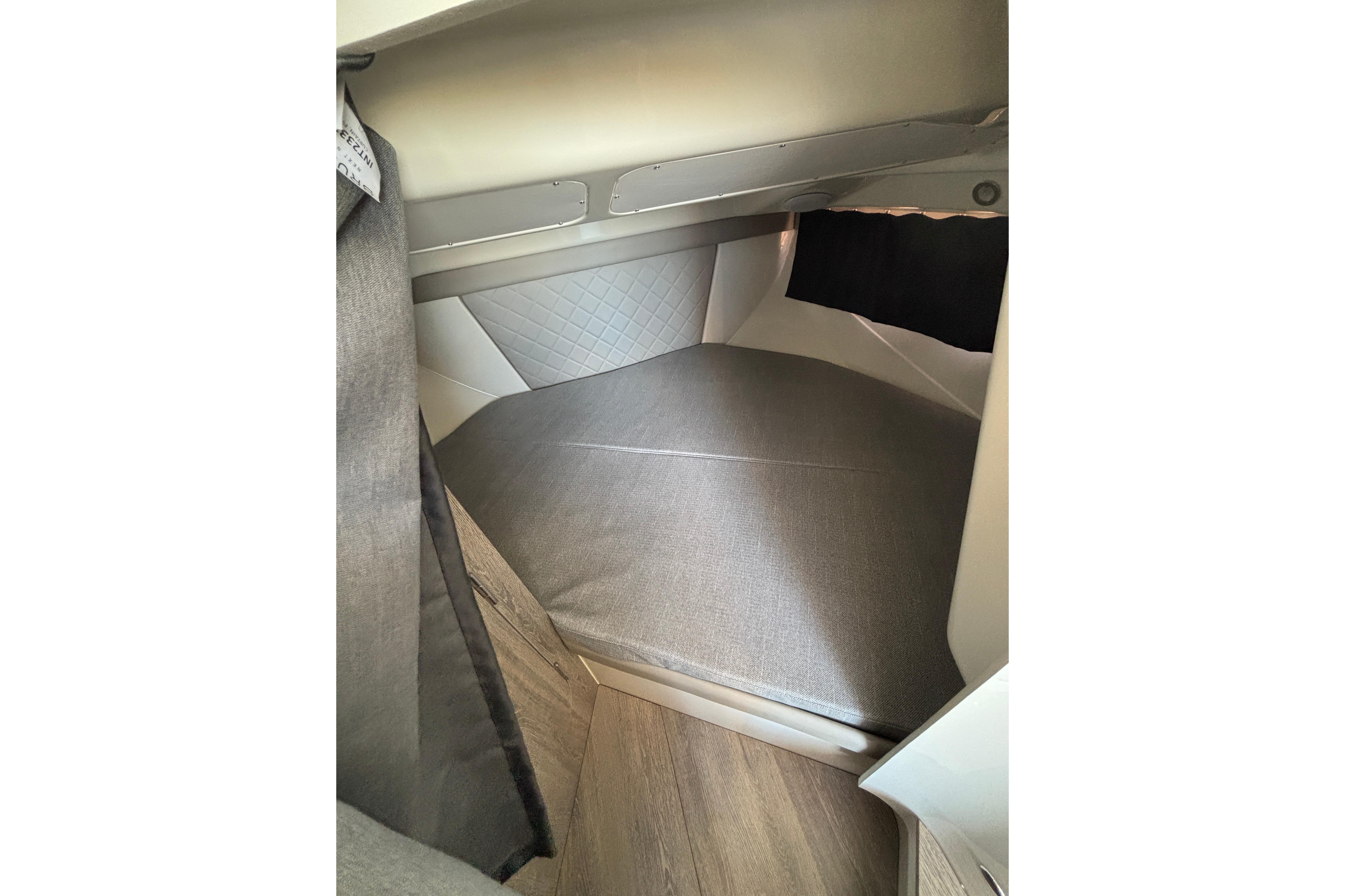 Interior cabin of 2026 Trophy T 25 Explorer boat, featuring a cozy sleeping area.