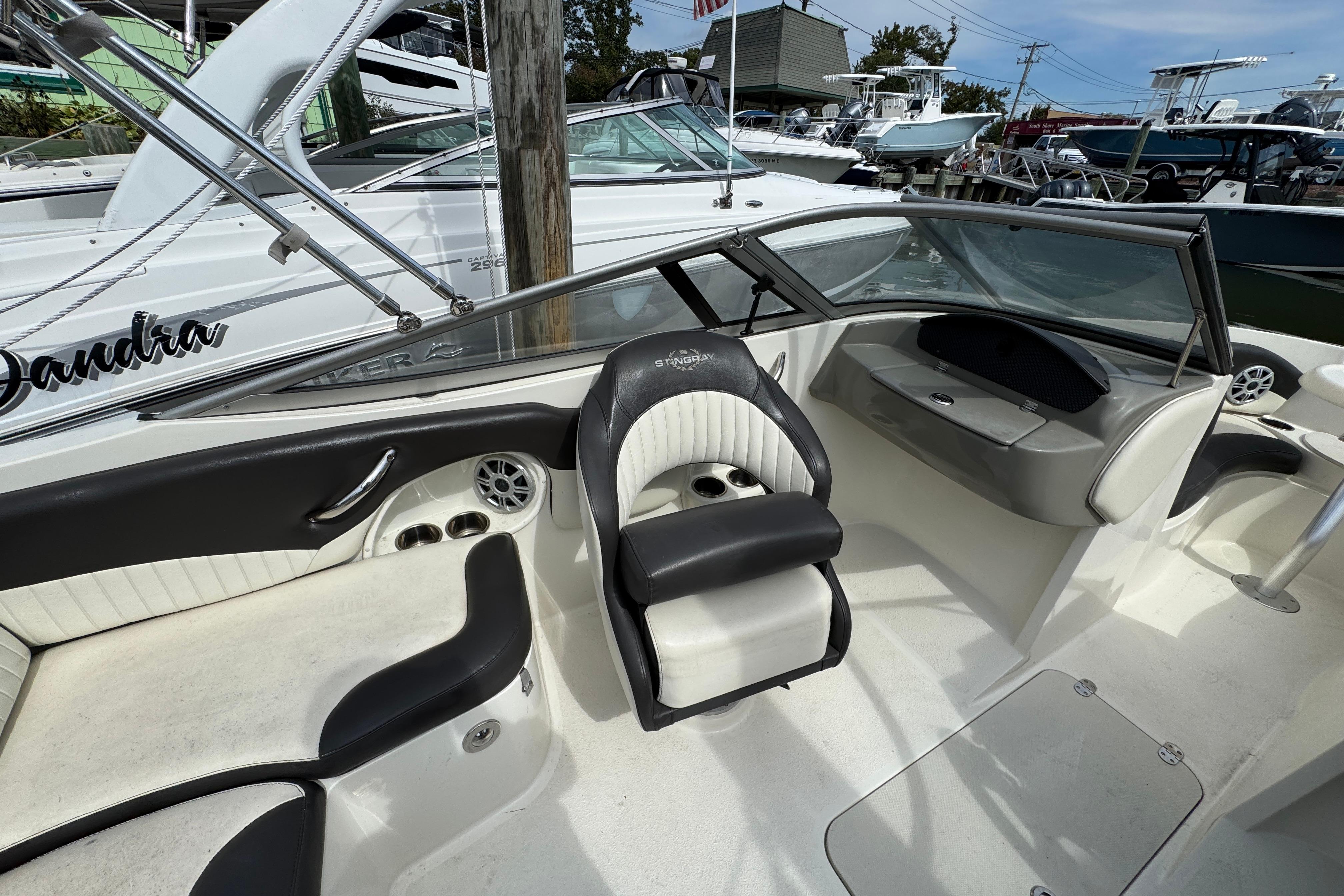 2018 Stingray 204 LR boat interior with seating and dashboard, docked at marina.
