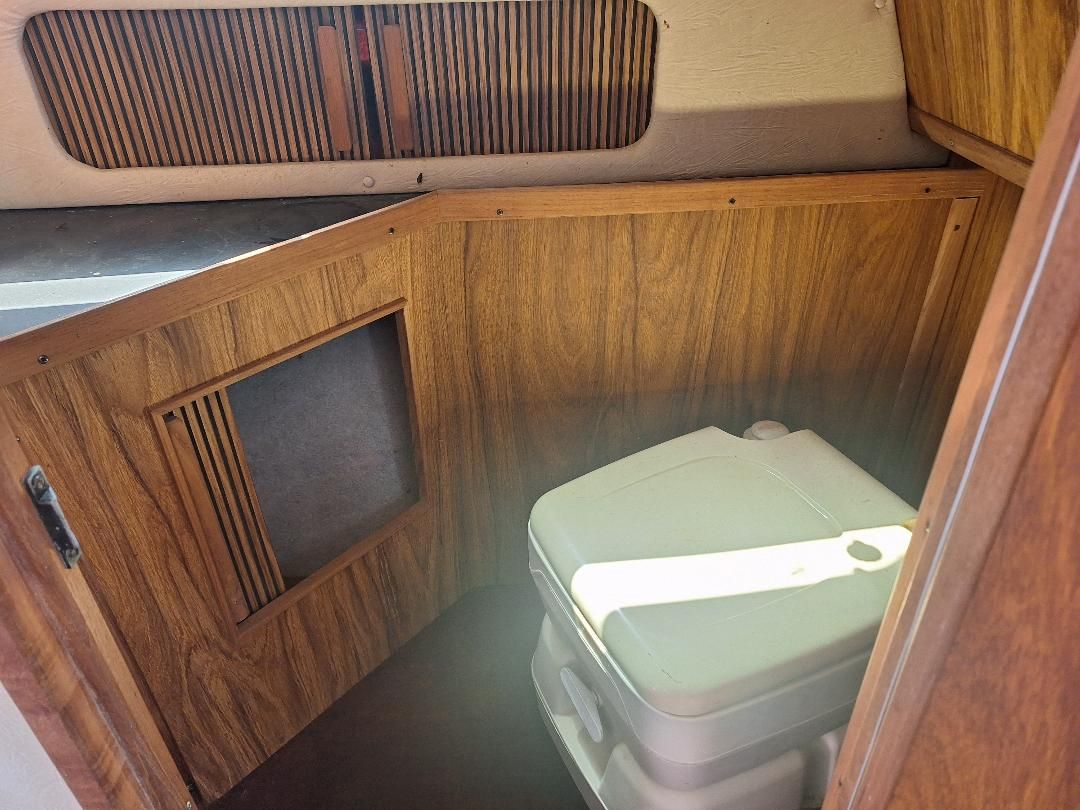 1986 Sea Ray Weekender 230 interior with portable toilet.