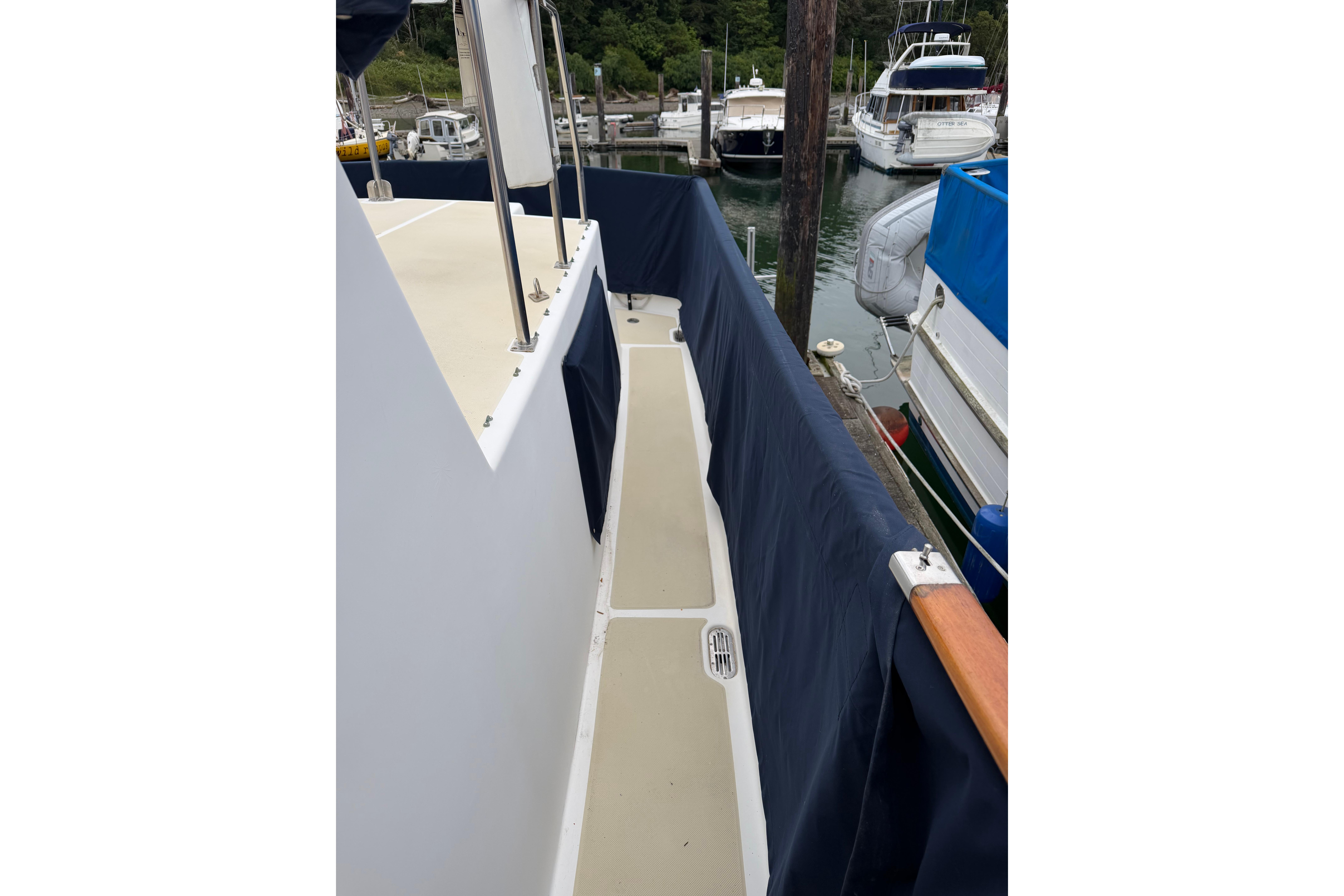 Side deck of a 1988 Monk 36 boat docked at a marina.