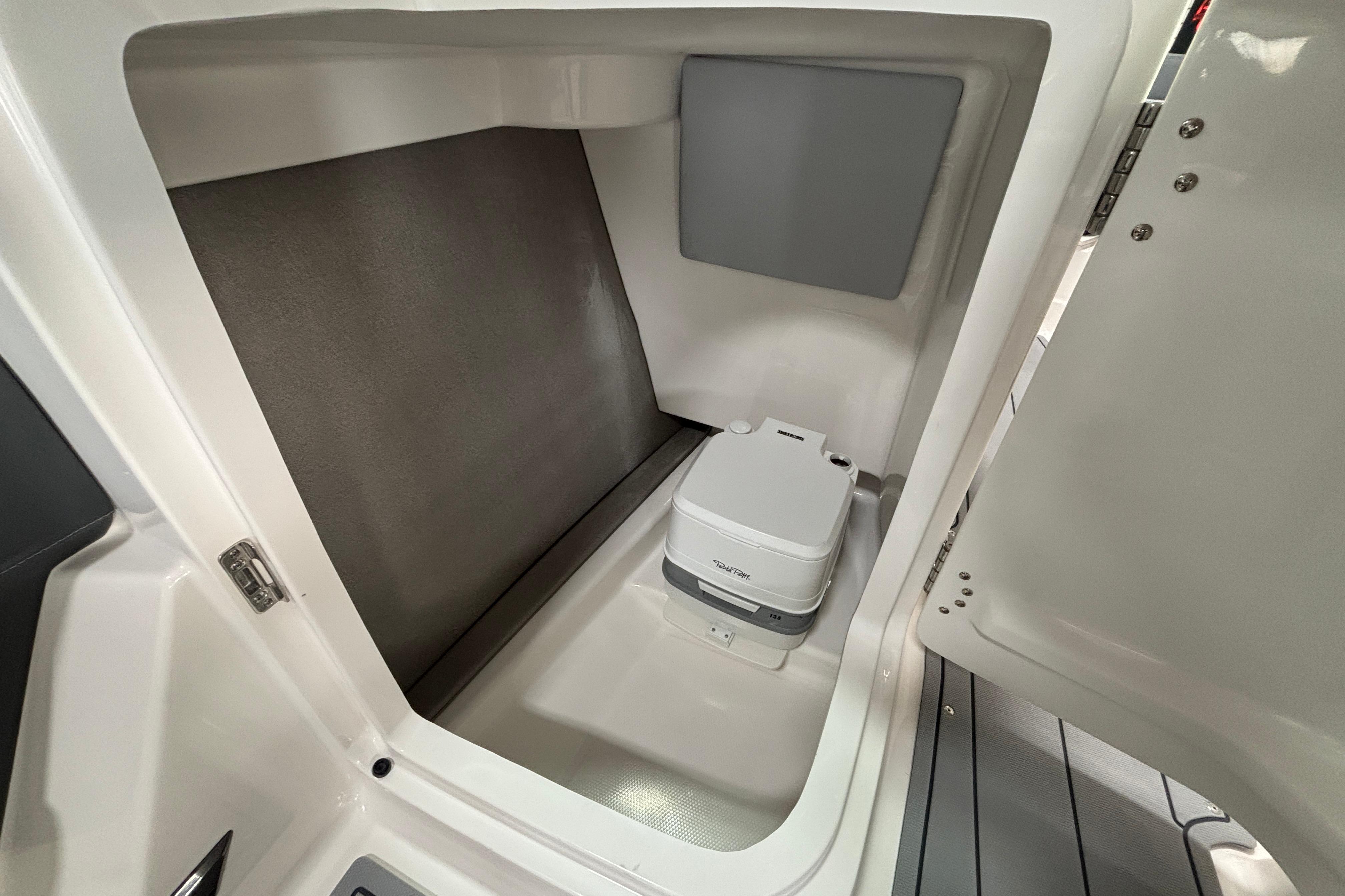 2026 Chaparral SSX 4 boat interior with compact portable toilet.