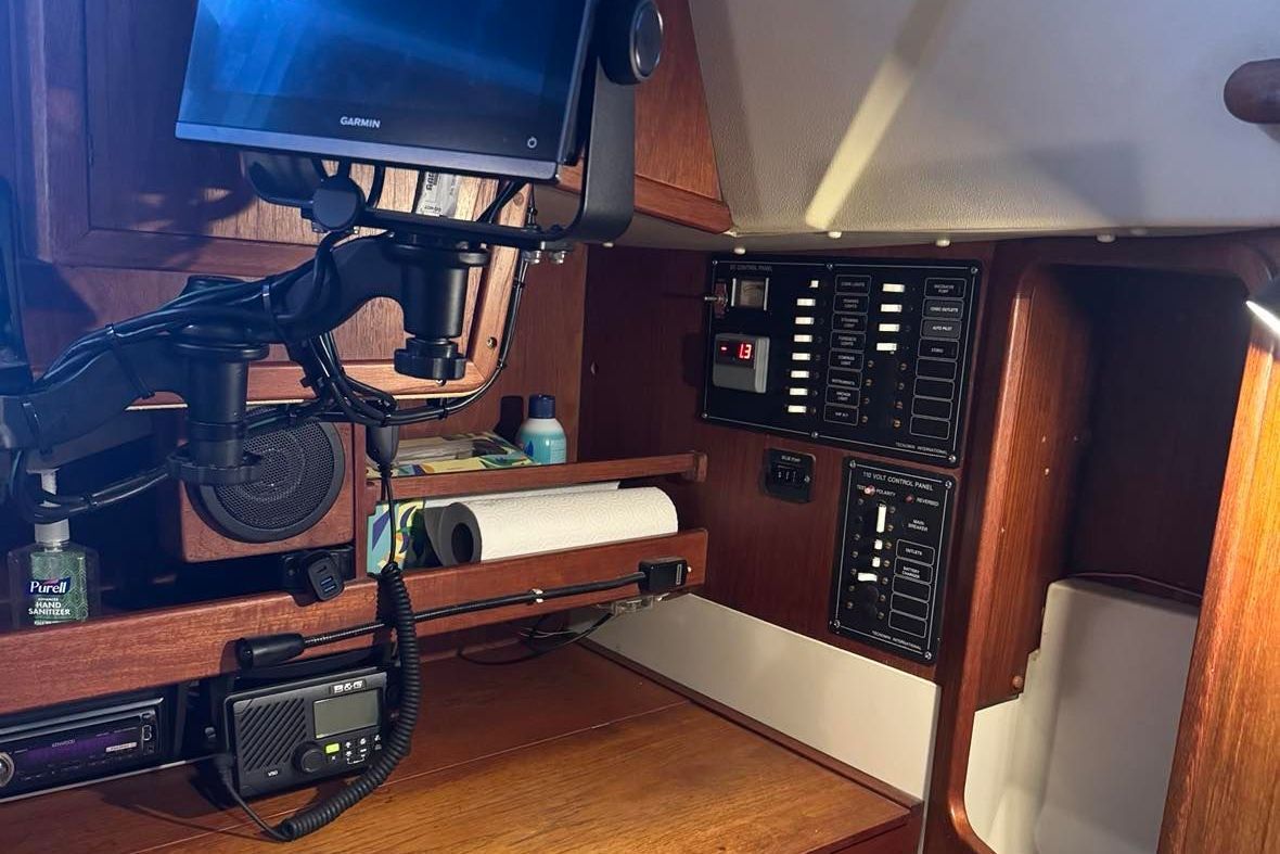 Interior view of a boat with navigation system and wood paneling.