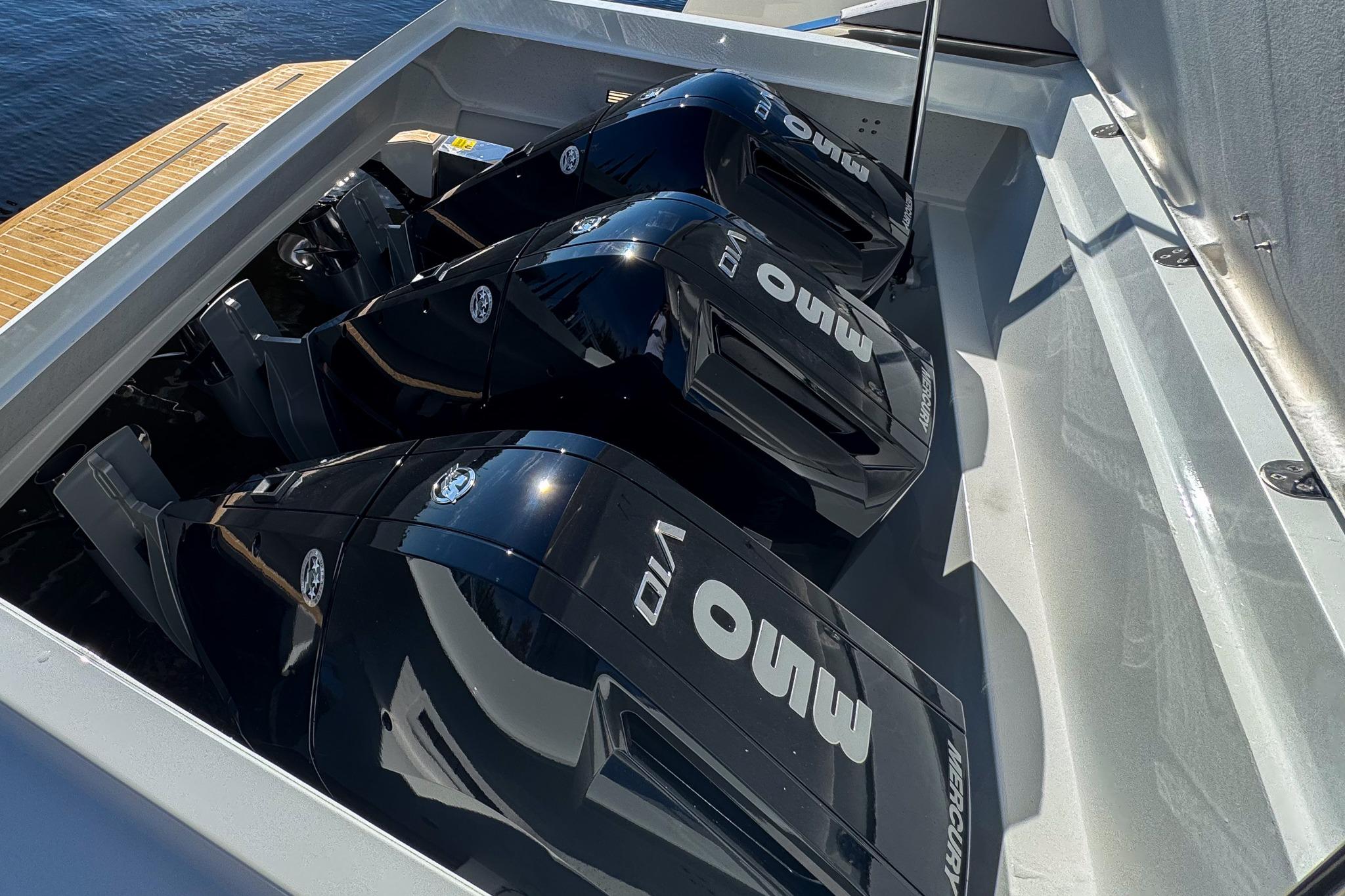 Triple outboard engines on 2026 De Antonio Yachts D42, docked on water.