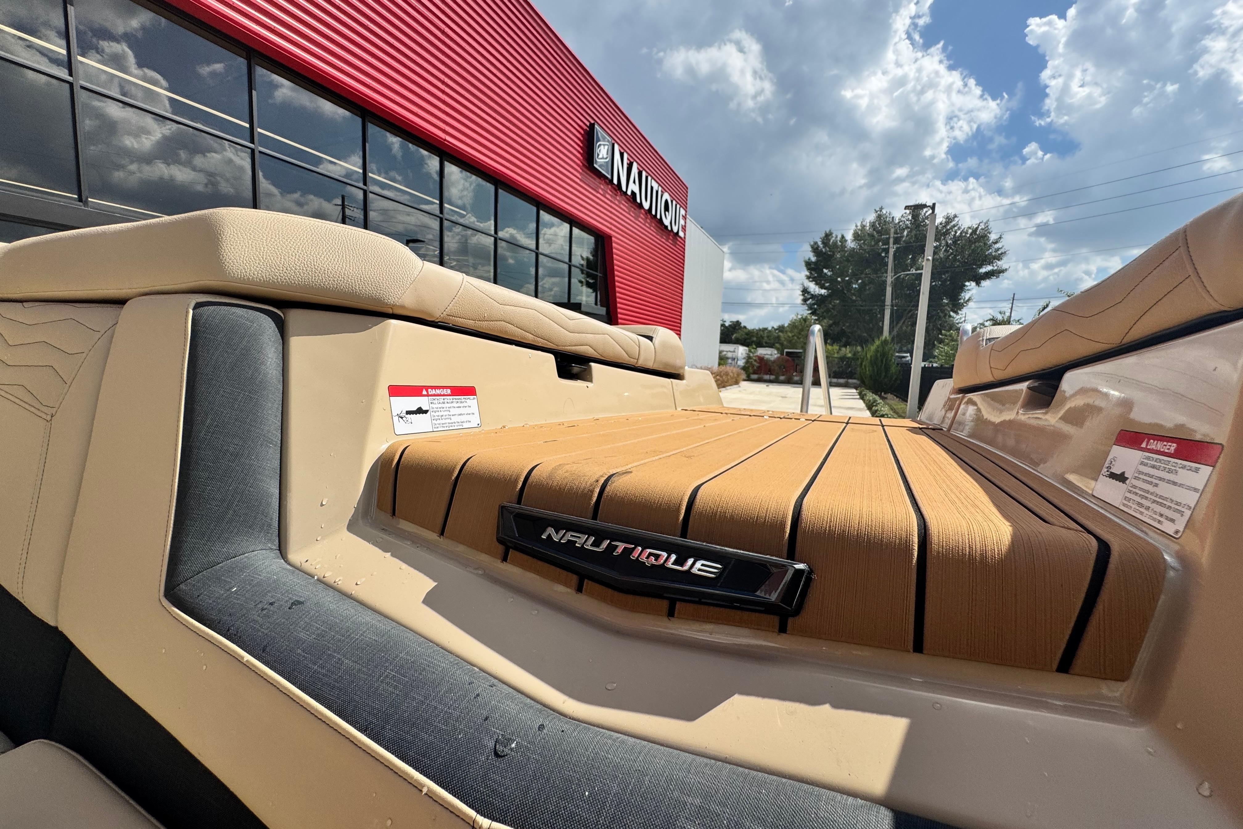 2026 Nautique Super Air Nautique G23 Paragon boat at dealership, sunny day.