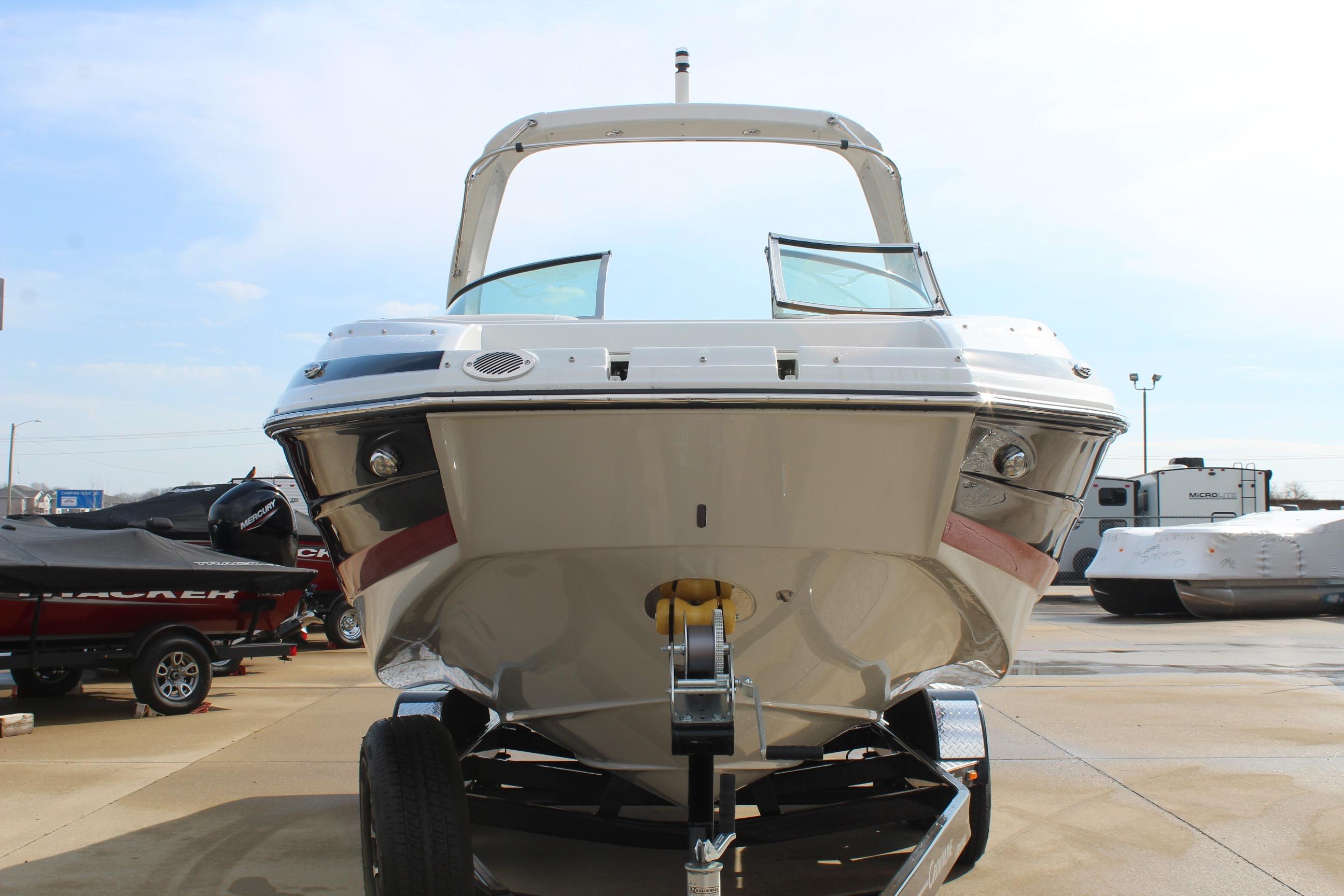 2026 Crownline Eclipse E255 boat on trailer, front view, in a marina setting.