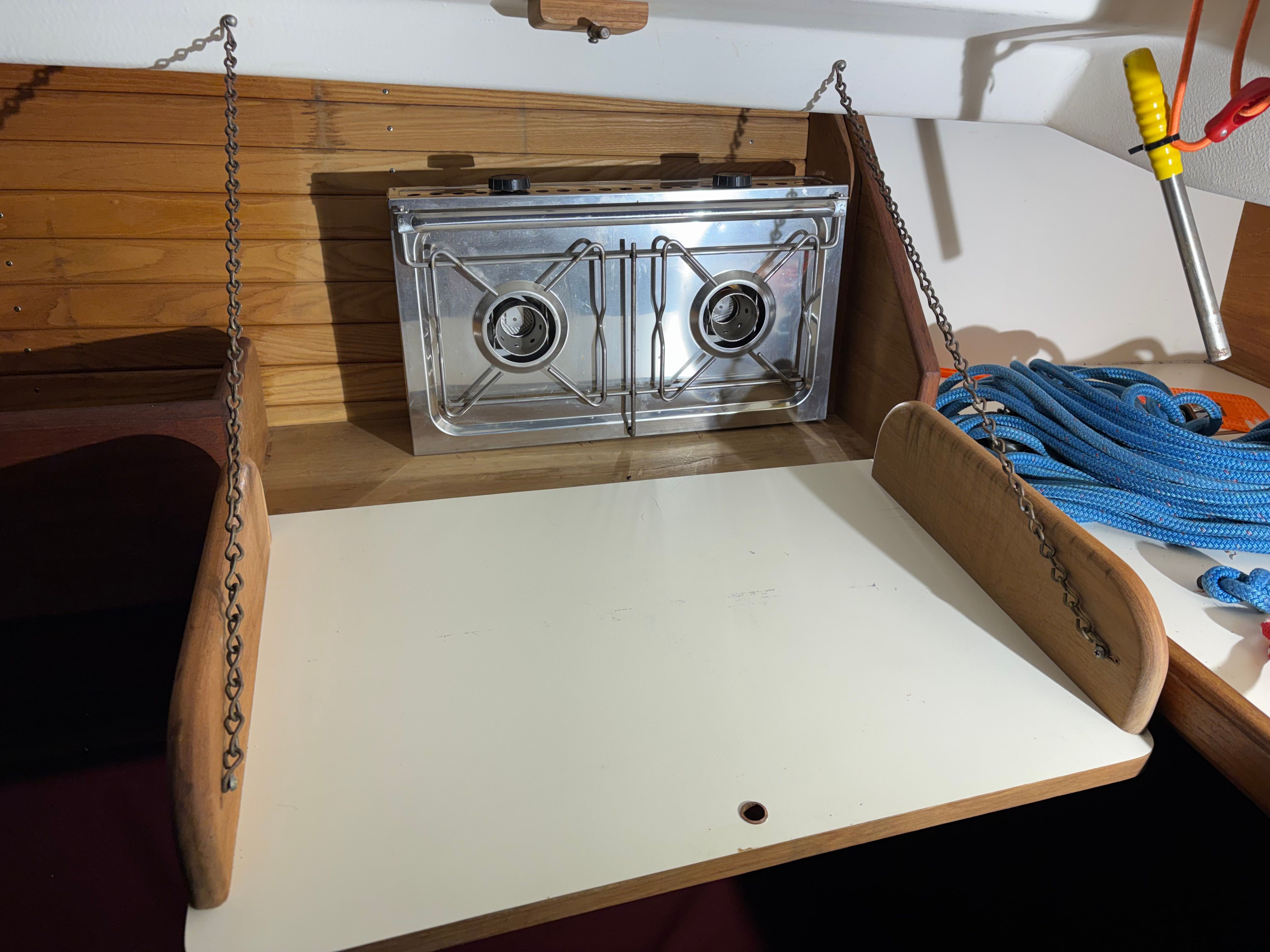 Interior of a 1986 Cape Dory 26 yacht with stove and rope.