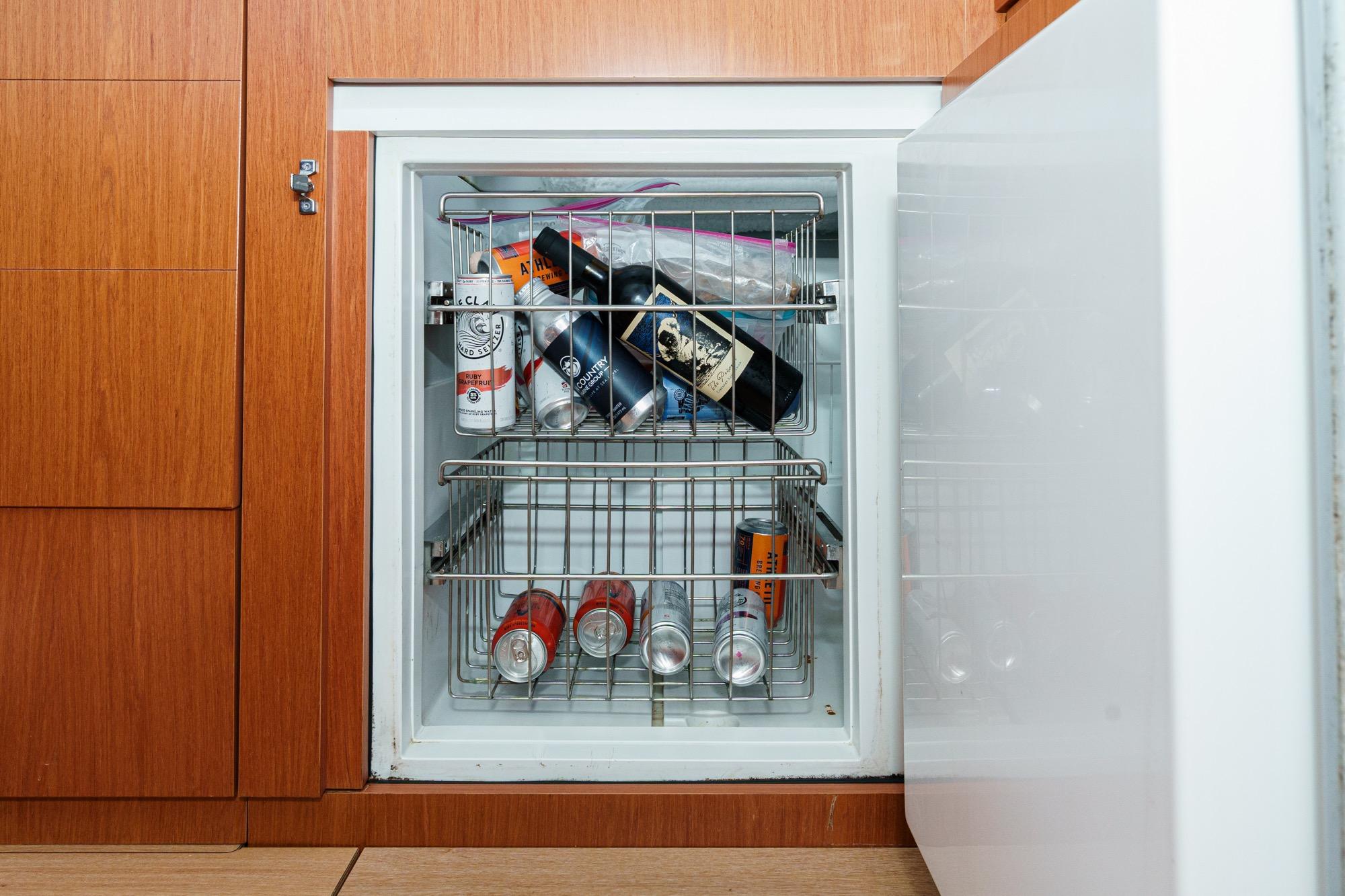 Mini fridge stocked with beverages on a 2017 Beneteau Sense 50 yacht.