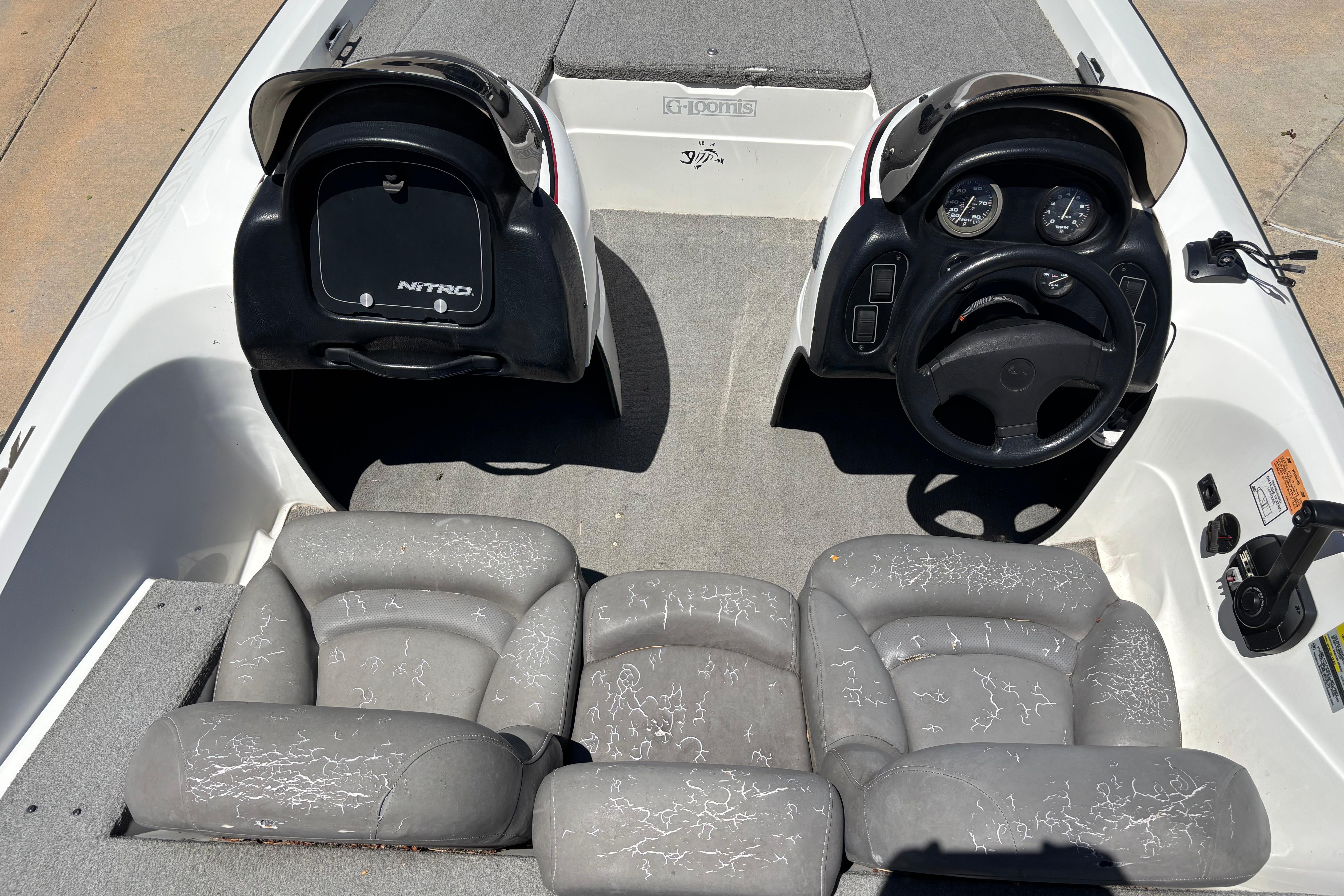 1998 Nitro 700 LX DC boat interior with dual consoles and gray seating.