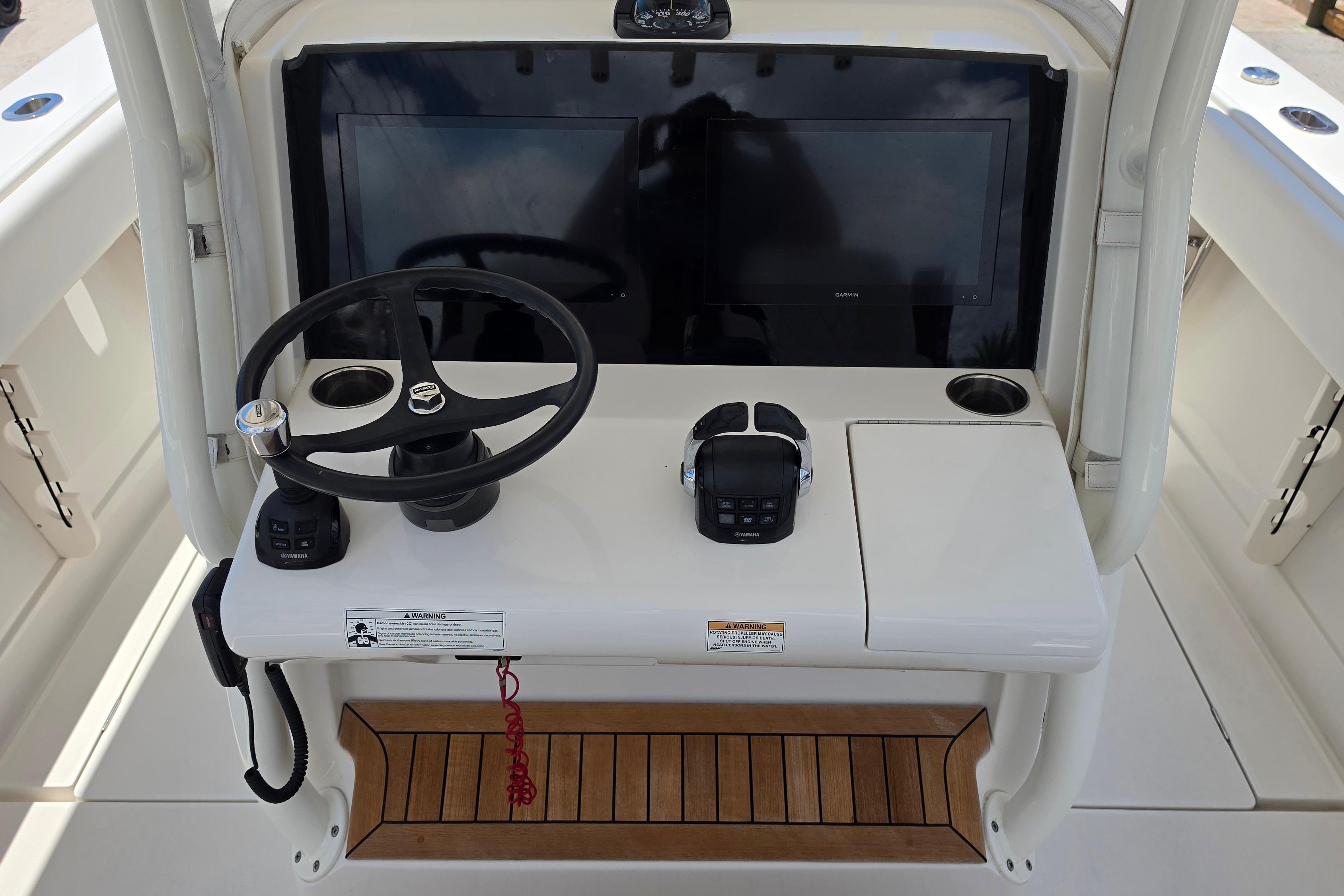 2020 Jupiter 34 HFS boat helm with steering wheel, controls, and display screen.