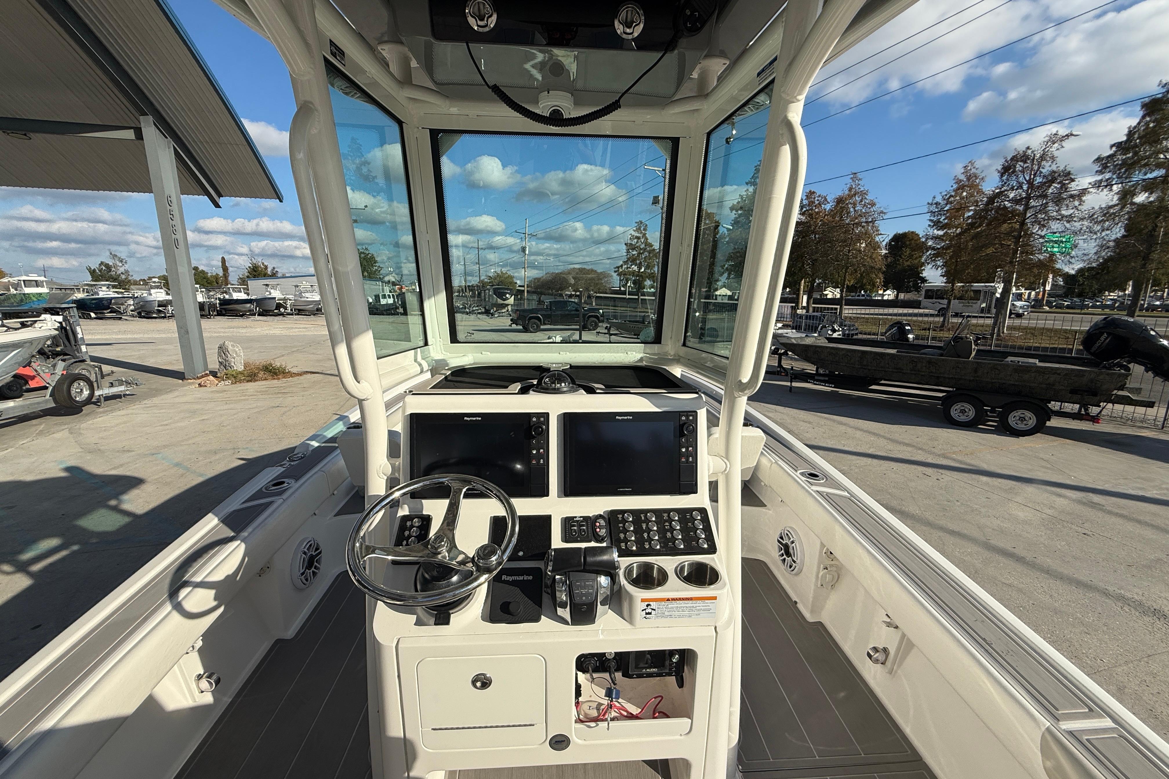 2022 Caymas 28 HB Twin boat cockpit with modern controls and steering wheel.