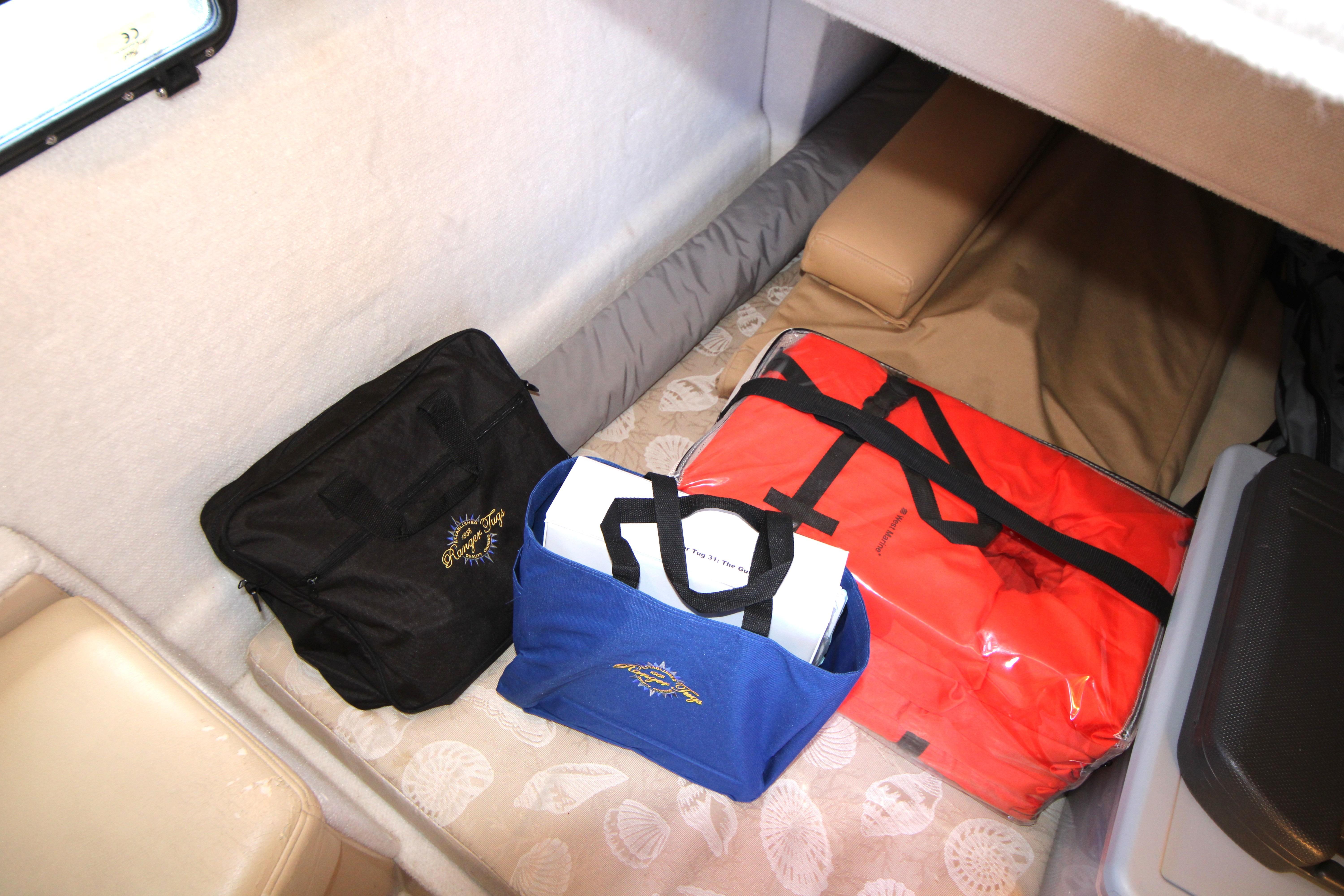 Interior cabin of 2013 Ranger Tugs R-31 CB with storage bags on bed.