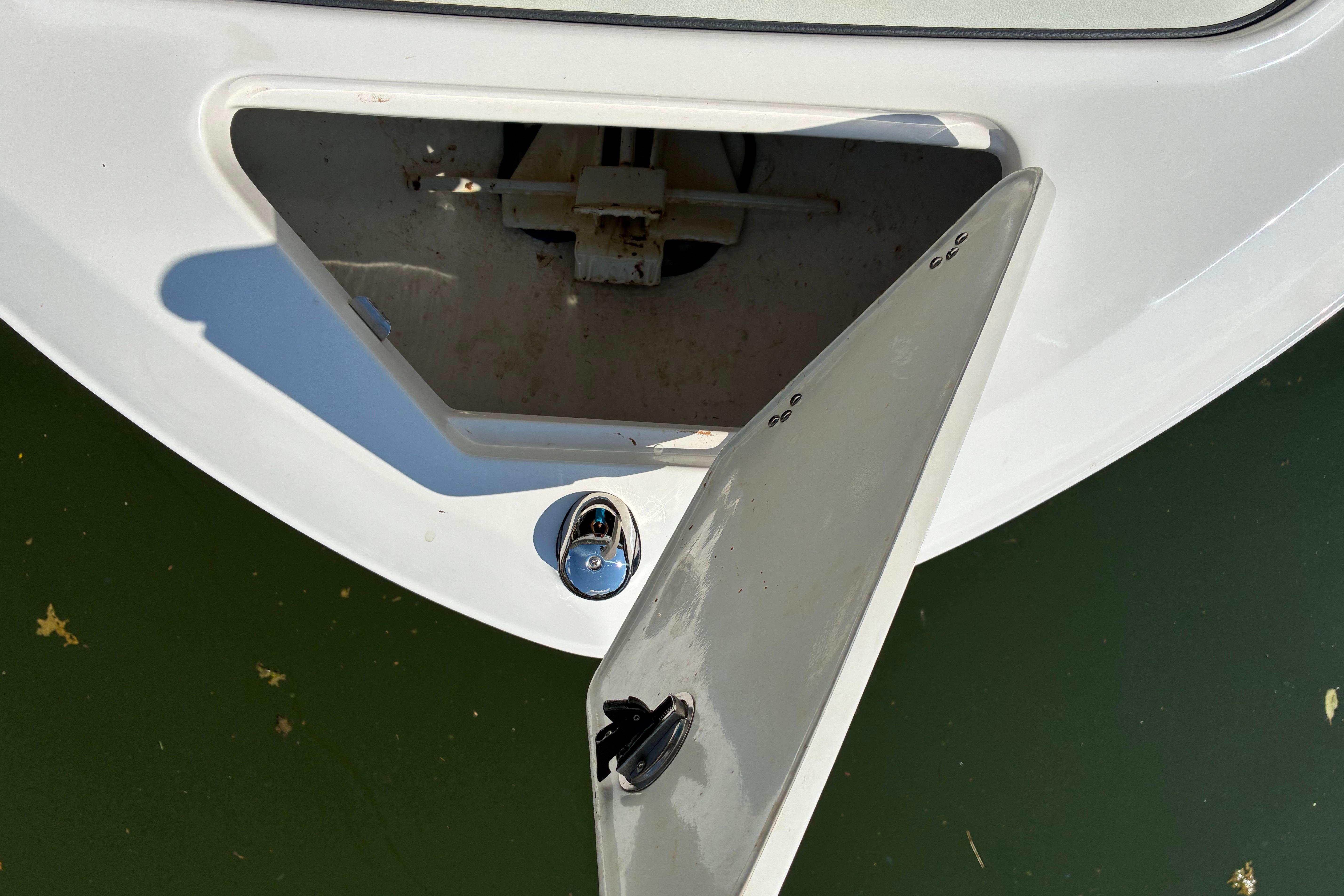 Open storage compartment on 2025 Regal LS2 boat, showing interior details.