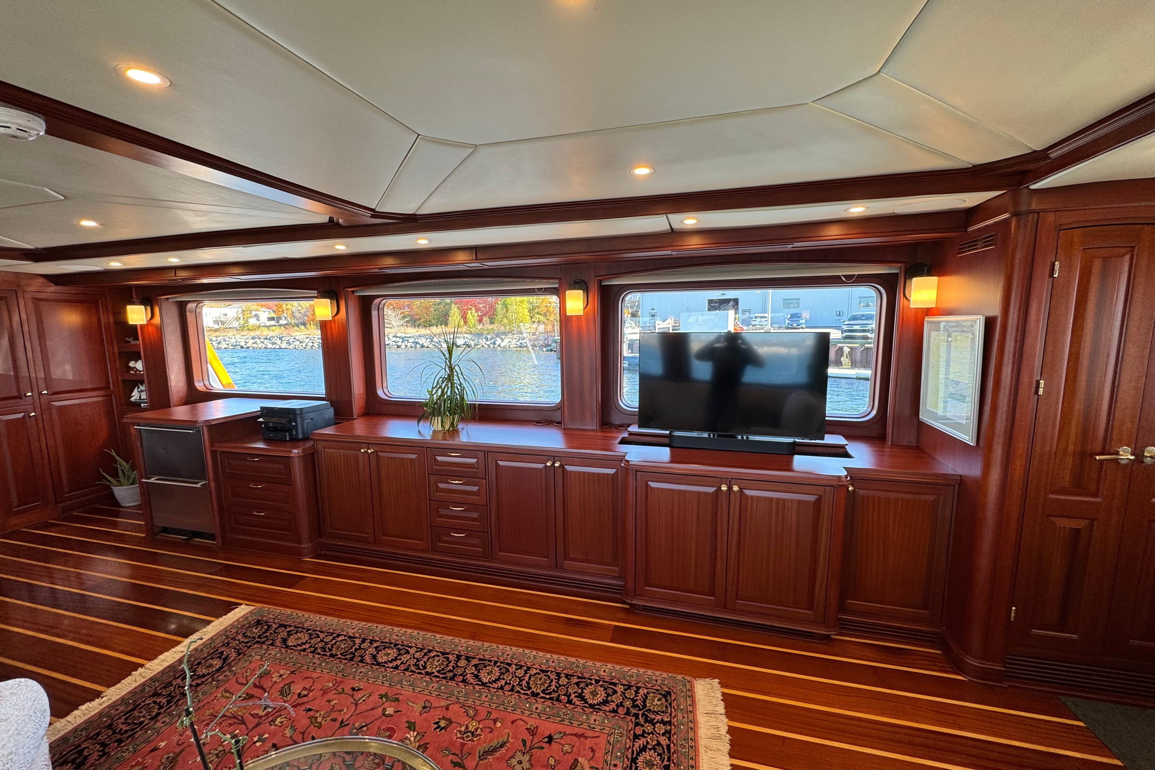 Luxurious yacht interior with wooden cabinetry, large windows, and a TV, Doogersbank Vipack 2001.