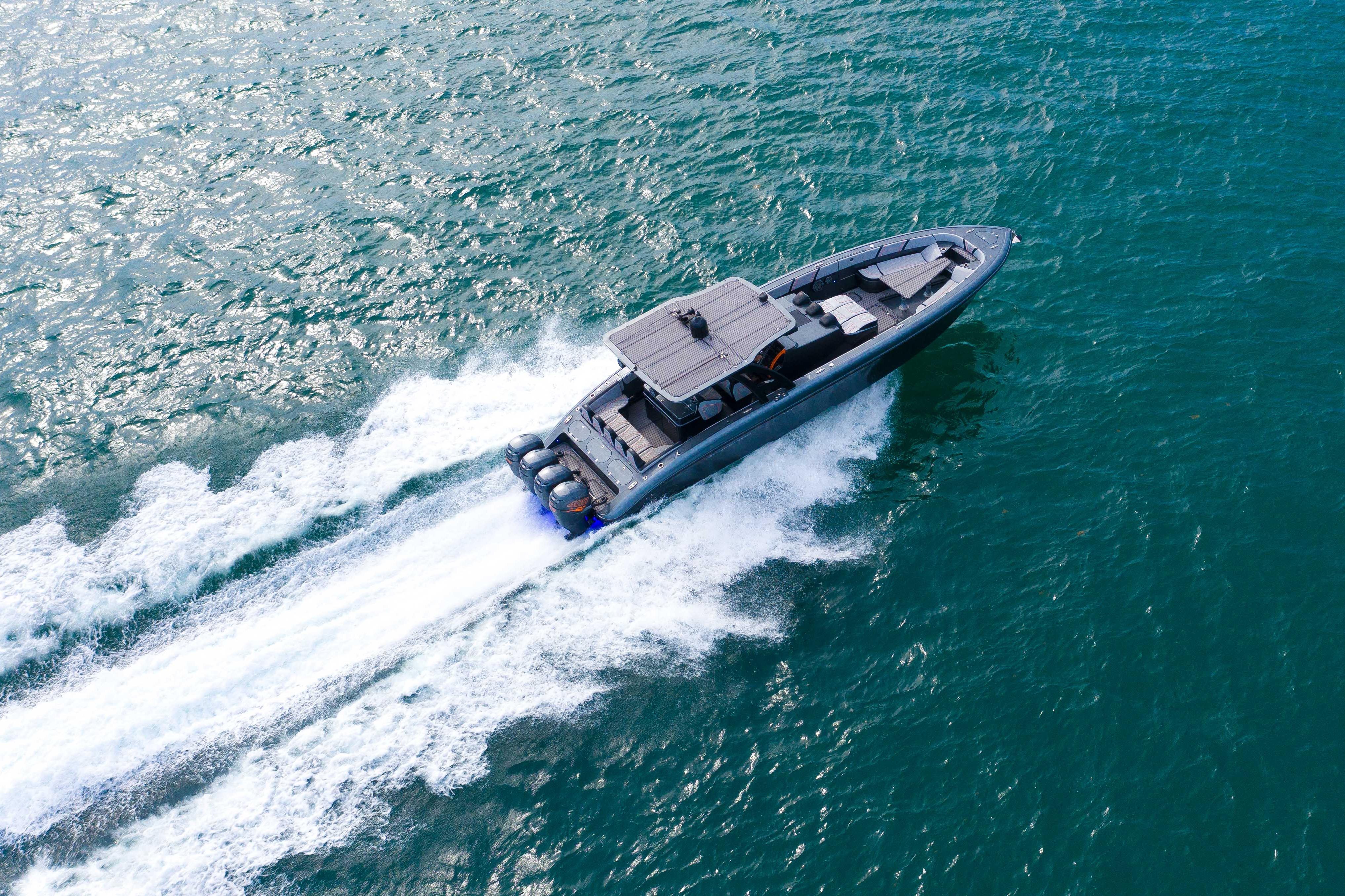 Aerial view of 2019 Midnight Express 43 Open boat speeding on ocean waters.