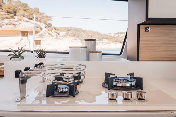 Modern kitchen on 2025 Nautitech 44 Open yacht with sleek stove and scenic view.