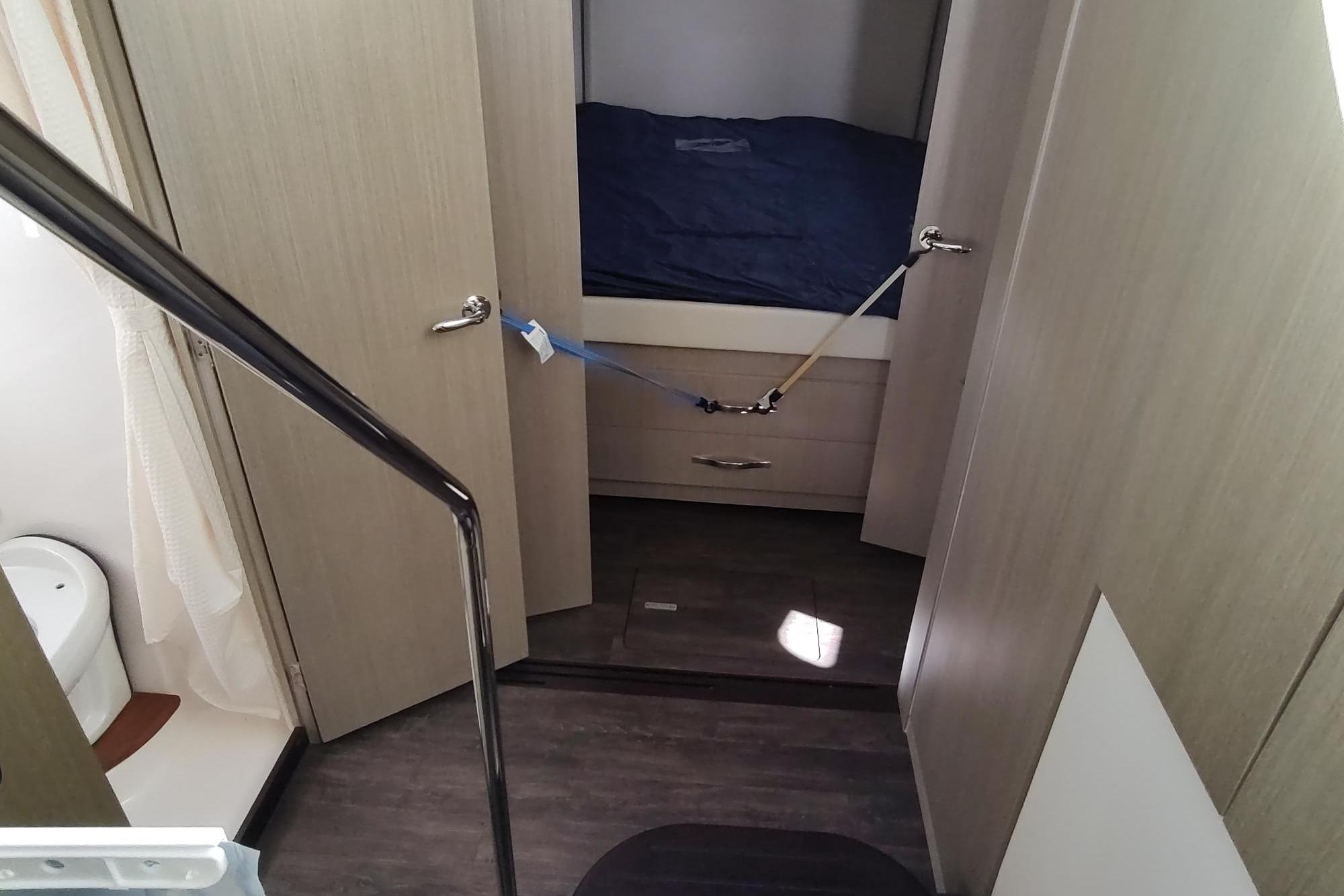 Interior of 2021 Regal 42 Fly yacht showing bedroom and bathroom.