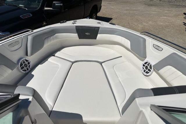 2023 Chaparral 23 SSi boat interior with white cushioned seating and speakers.