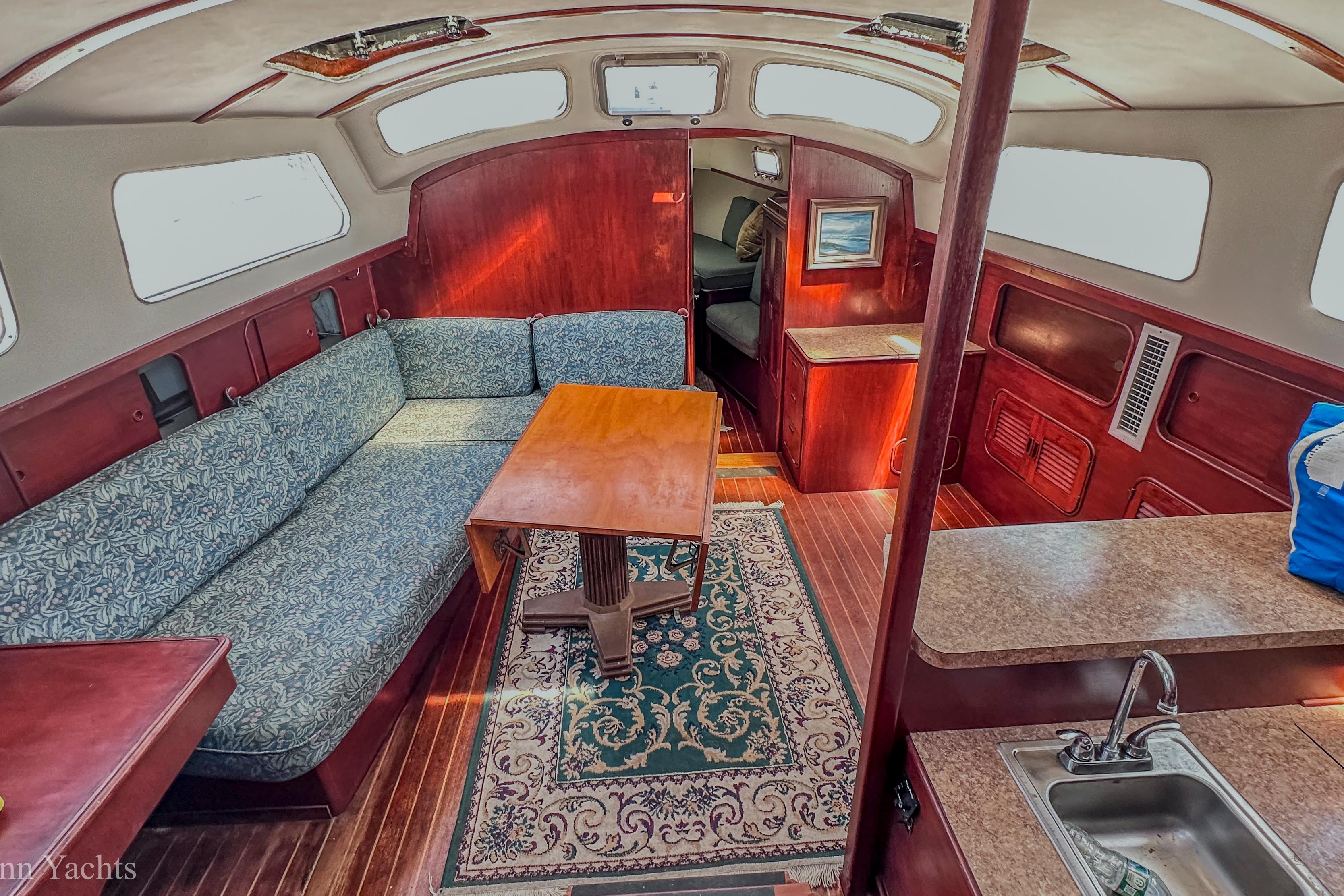 Interior of 1980 Irwin 46 yacht with cozy seating and wooden furnishings.