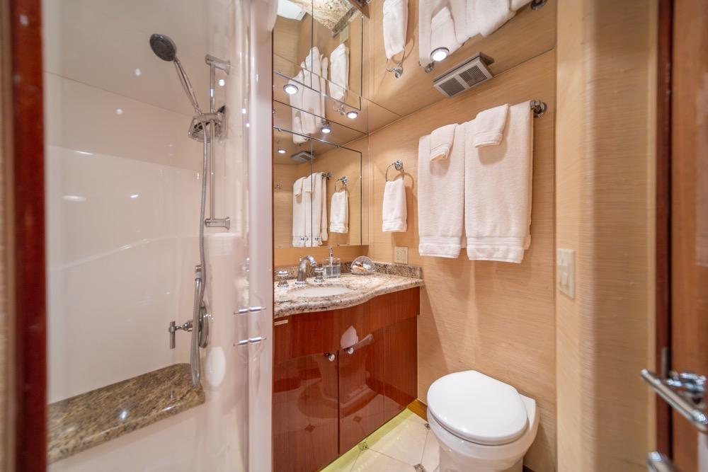 Luxurious bathroom in 2008 Hatteras 72 Motor Yacht with elegant fixtures and granite countertop.