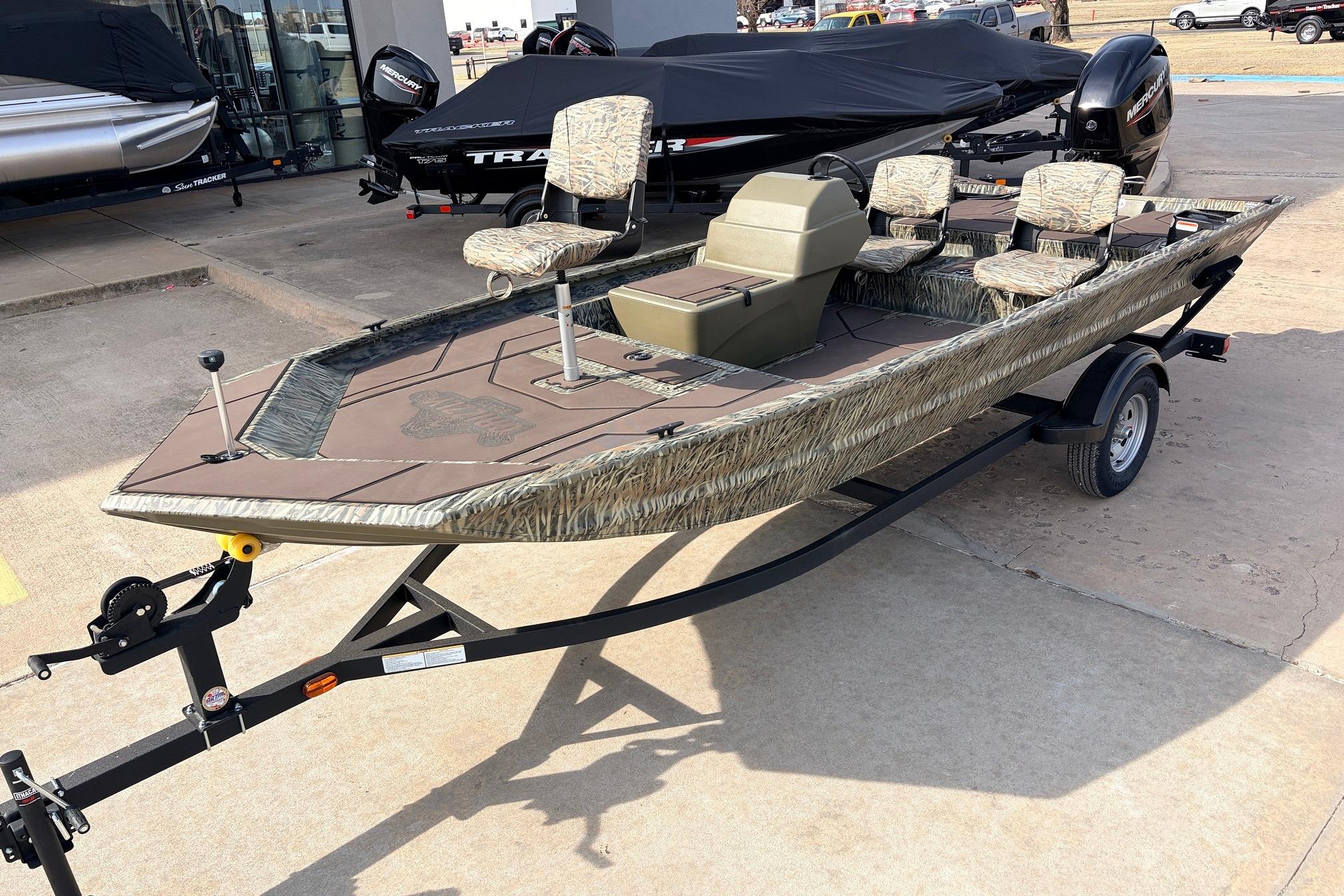 2026 Tracker Grizzly 1754 SC boat on trailer, camo design, outdoor display.