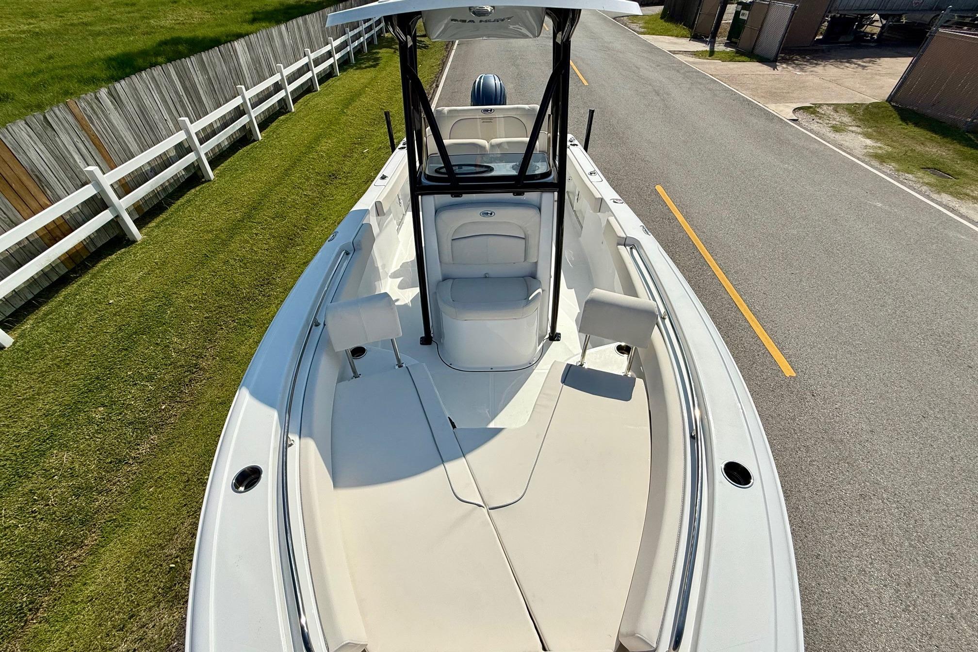 2026 Sea Hunt Ultra 229 boat on road, top view, white interior, sunny day.