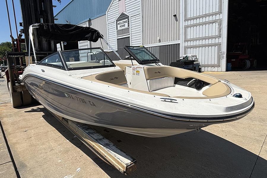 2018 Sea Ray SPX 190 boat on a forklift near a warehouse.