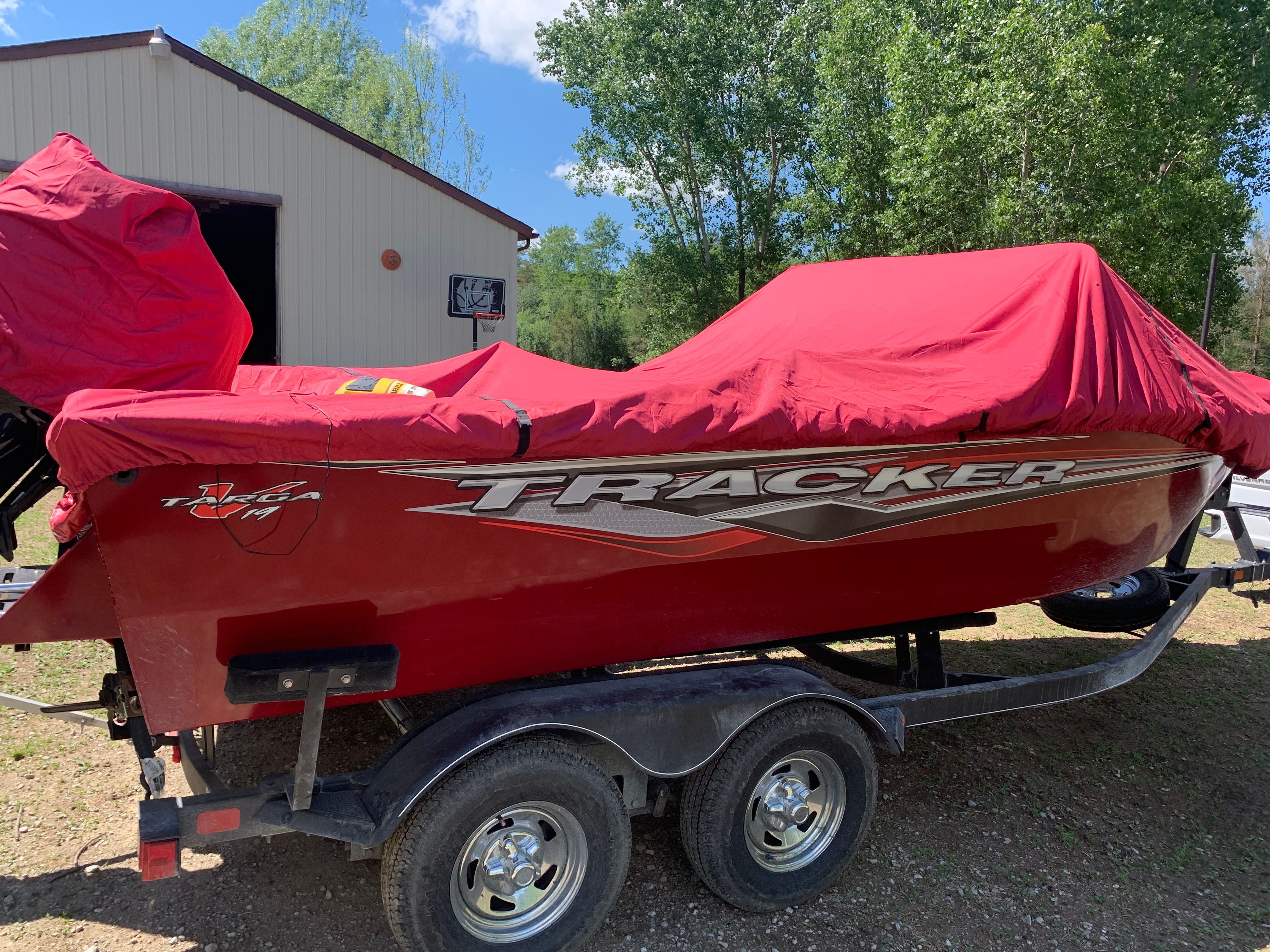 2022 Tracker Targa V-19 WT boat with red cover on trailer.