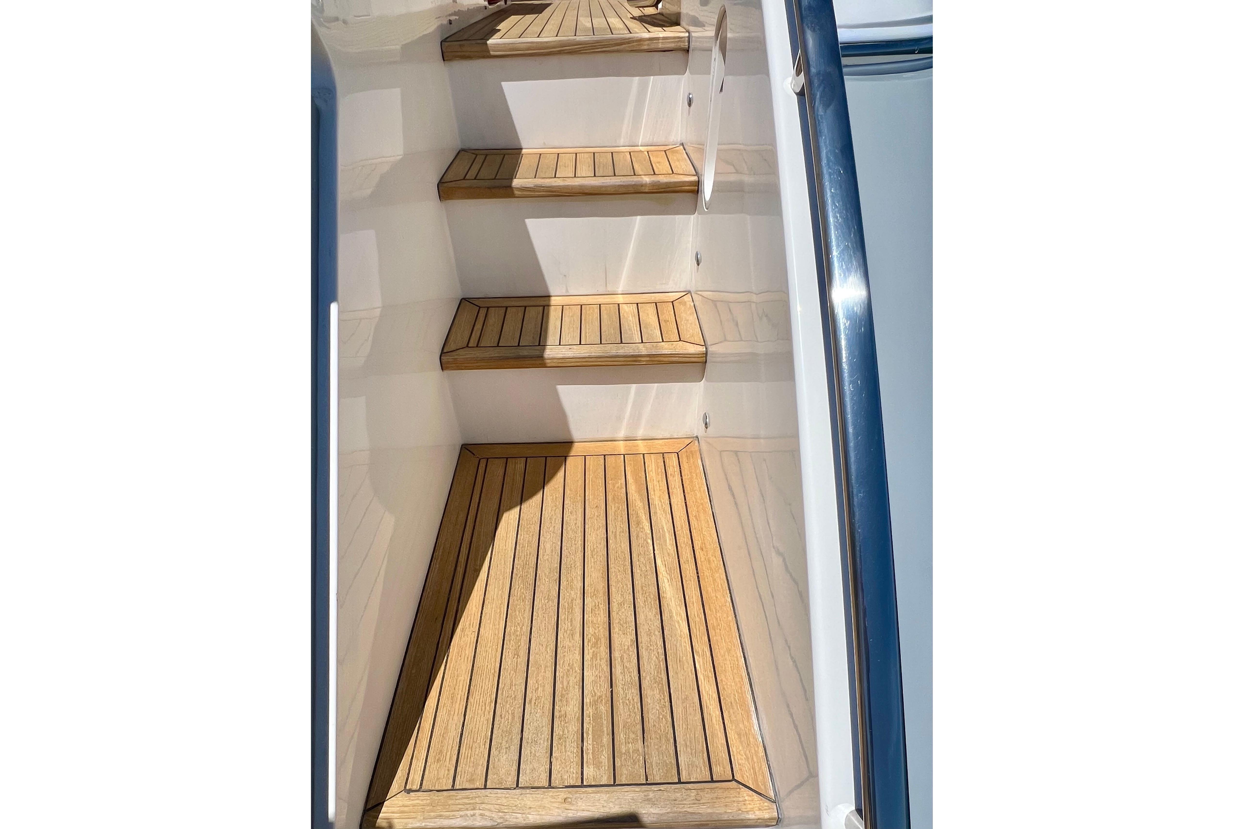 Wooden steps on a 2010 Princess V78 yacht, featuring sleek design and polished finish.