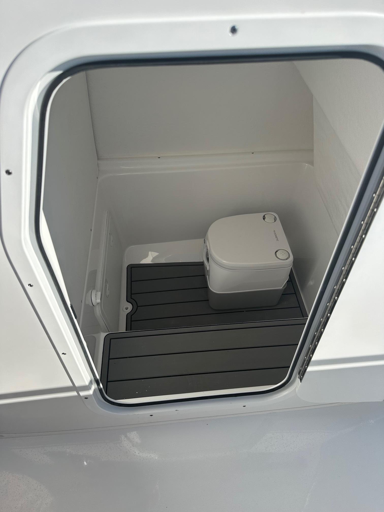 2025 Cape Horn 28XS boat interior with compact marine toilet.