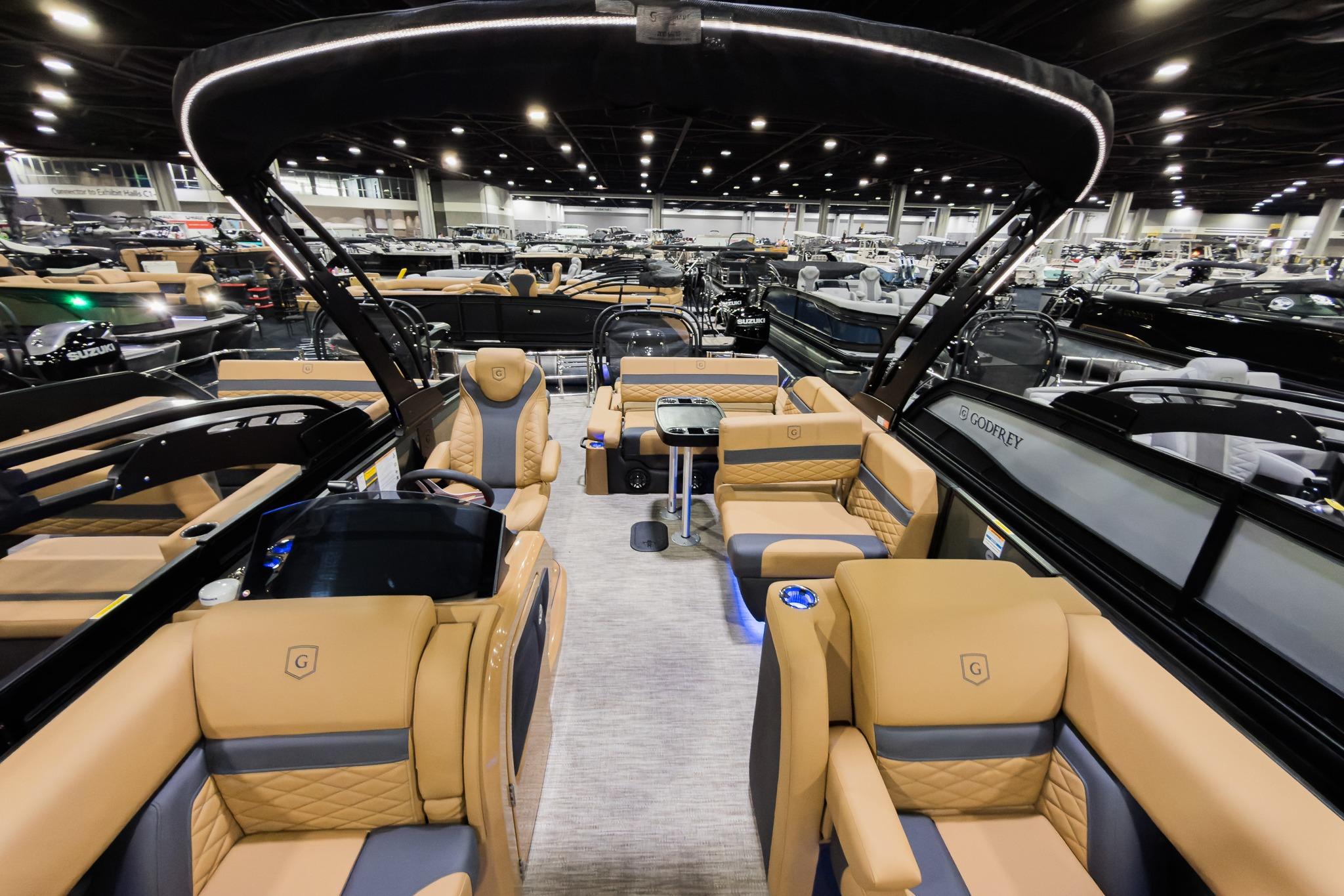 Luxurious 2026 Godfrey Monaco 255 boat interior with tan seating and modern design.