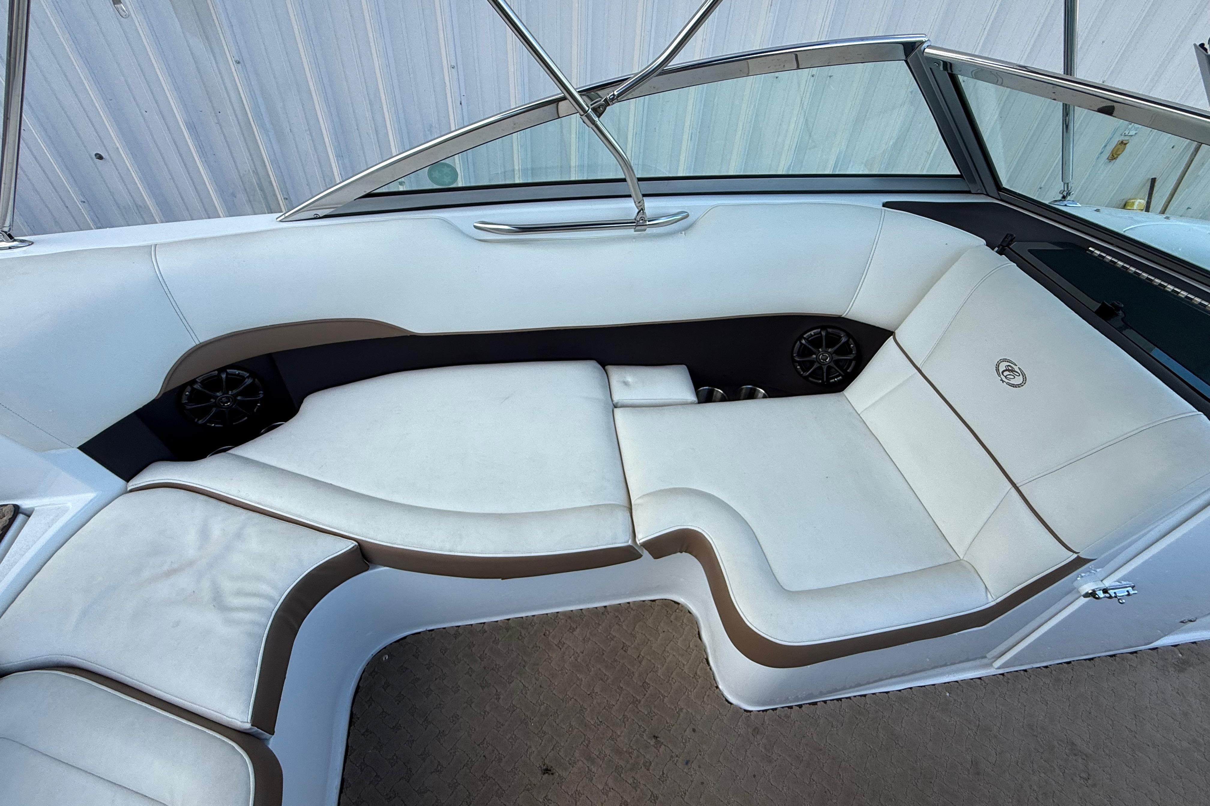 2015 Cobalt 200 boat interior with white and brown seating, featuring built-in speakers.