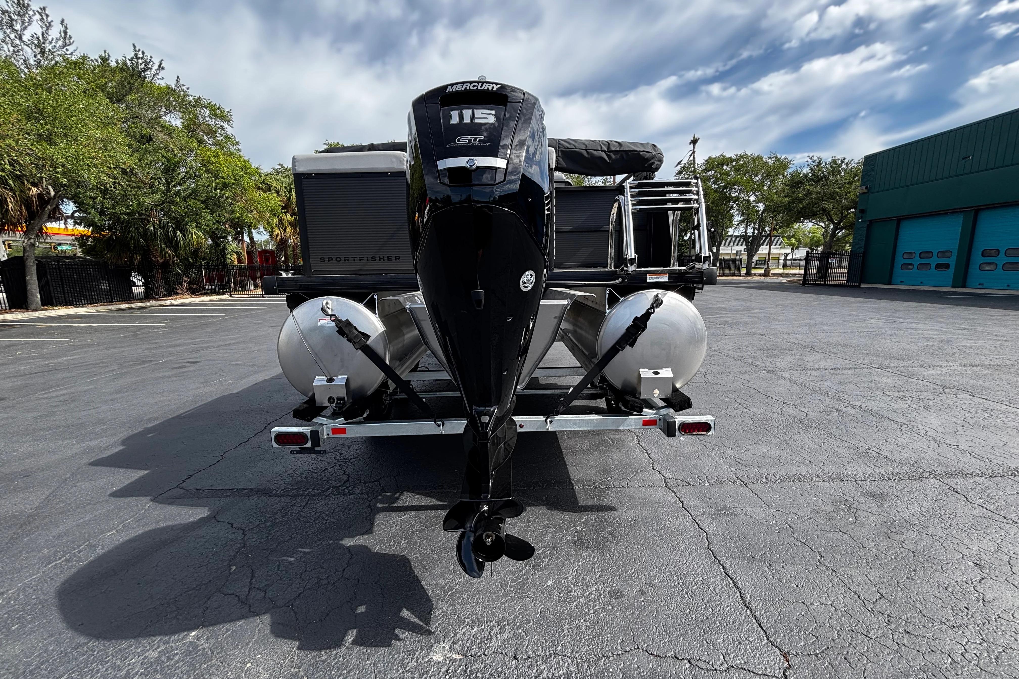 2026 Princecraft Sportfisher 21-2S boat with Mercury 115 engine, parked outdoors.