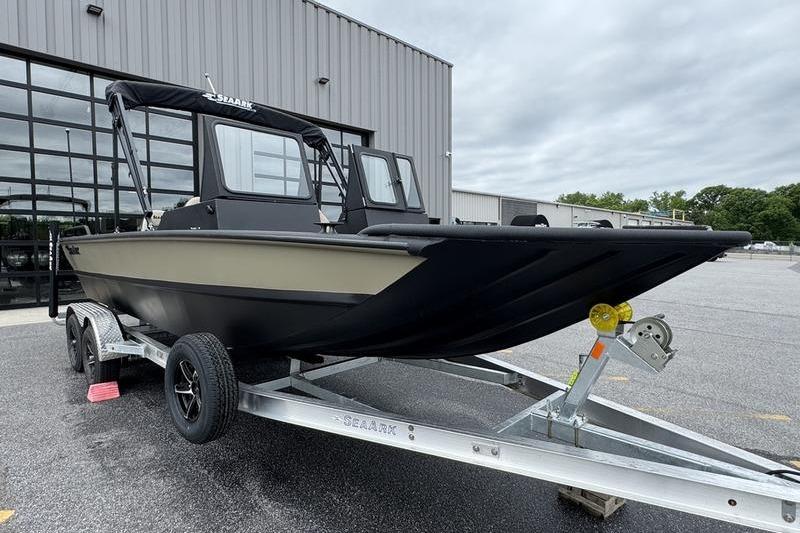 2026 SeaArk Predator 300 AK boat on trailer, parked outside a modern building.