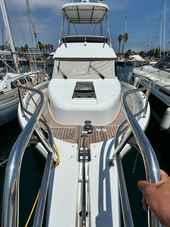 2022 Rodman 1290 Evolution yacht docked in marina, showcasing sleek design and spacious deck.