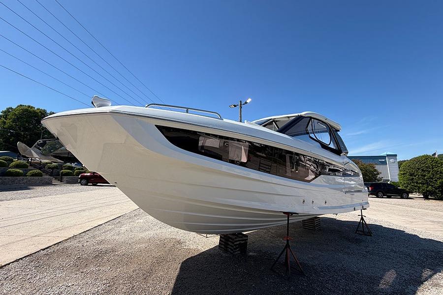 2024 Galeon 325 GTO yacht displayed outdoors on stands under clear blue sky.