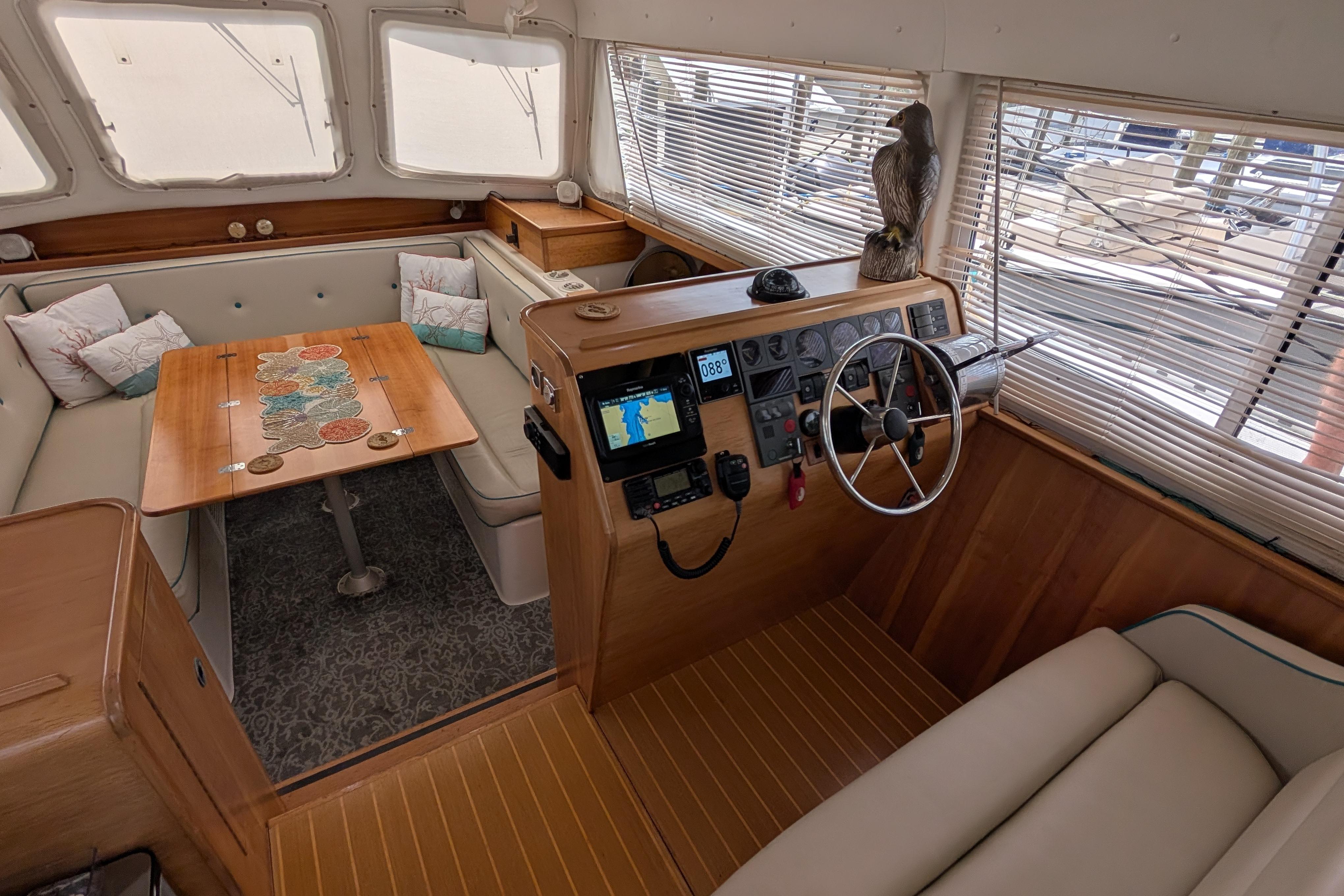 Interior of 2004 PDQ 34 Powercat, featuring helm, seating area, and nautical decor.