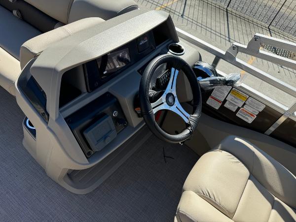 2025 Sun Tracker 24 Sportfish XP3 boat dashboard with steering wheel and controls.