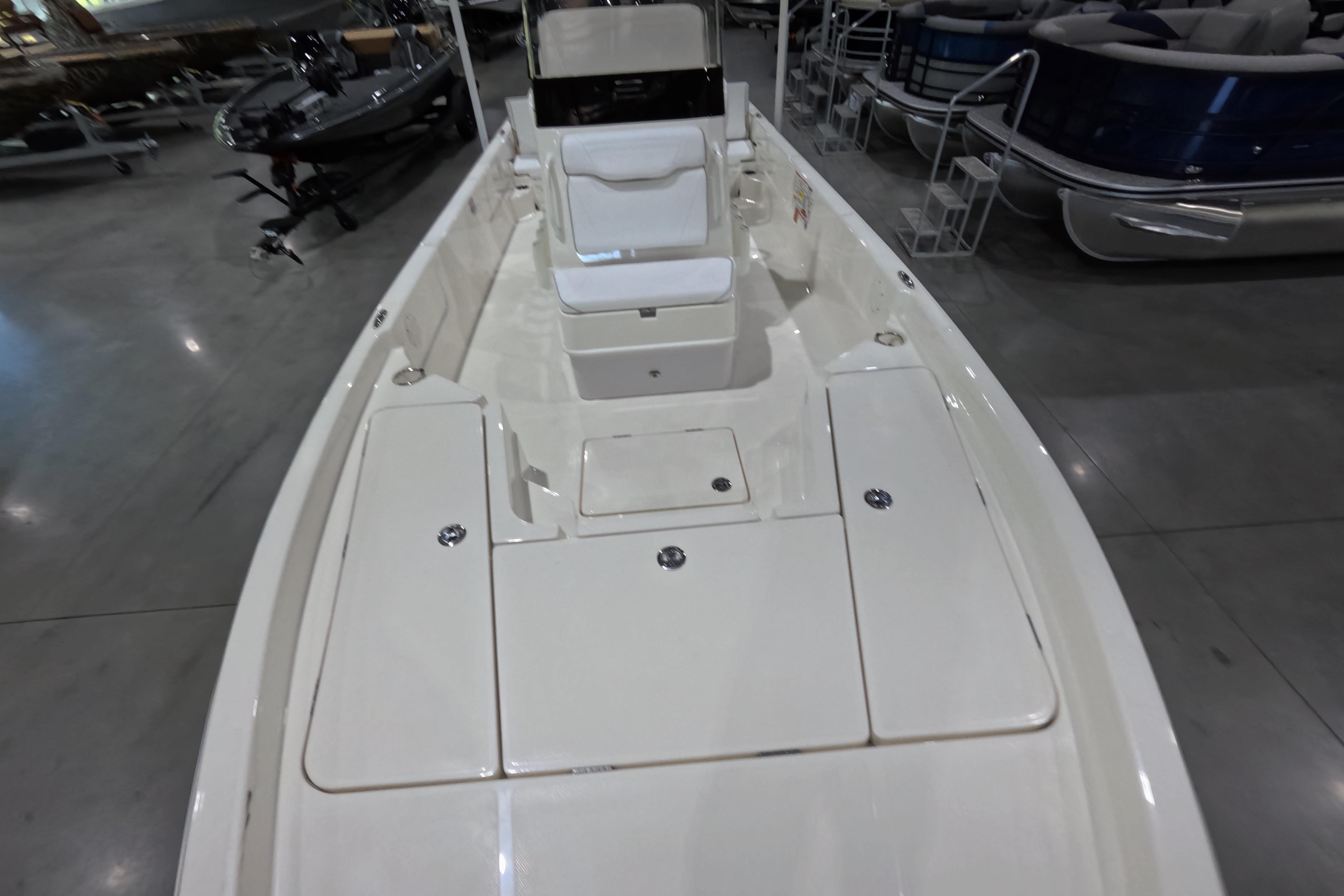 2026 Skeeter SX230 boat interior with white seating and storage compartments.