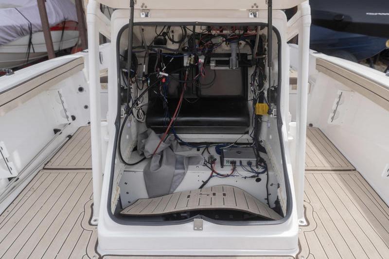 2023 Yamaha Boats 195 FSH Sport engine compartment with wiring and components visible.