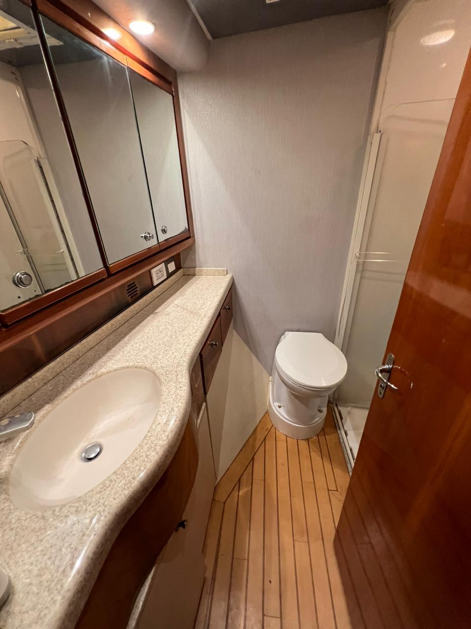Bathroom interior of a 2001 Bertram 510 Convertible yacht with sink and toilet.