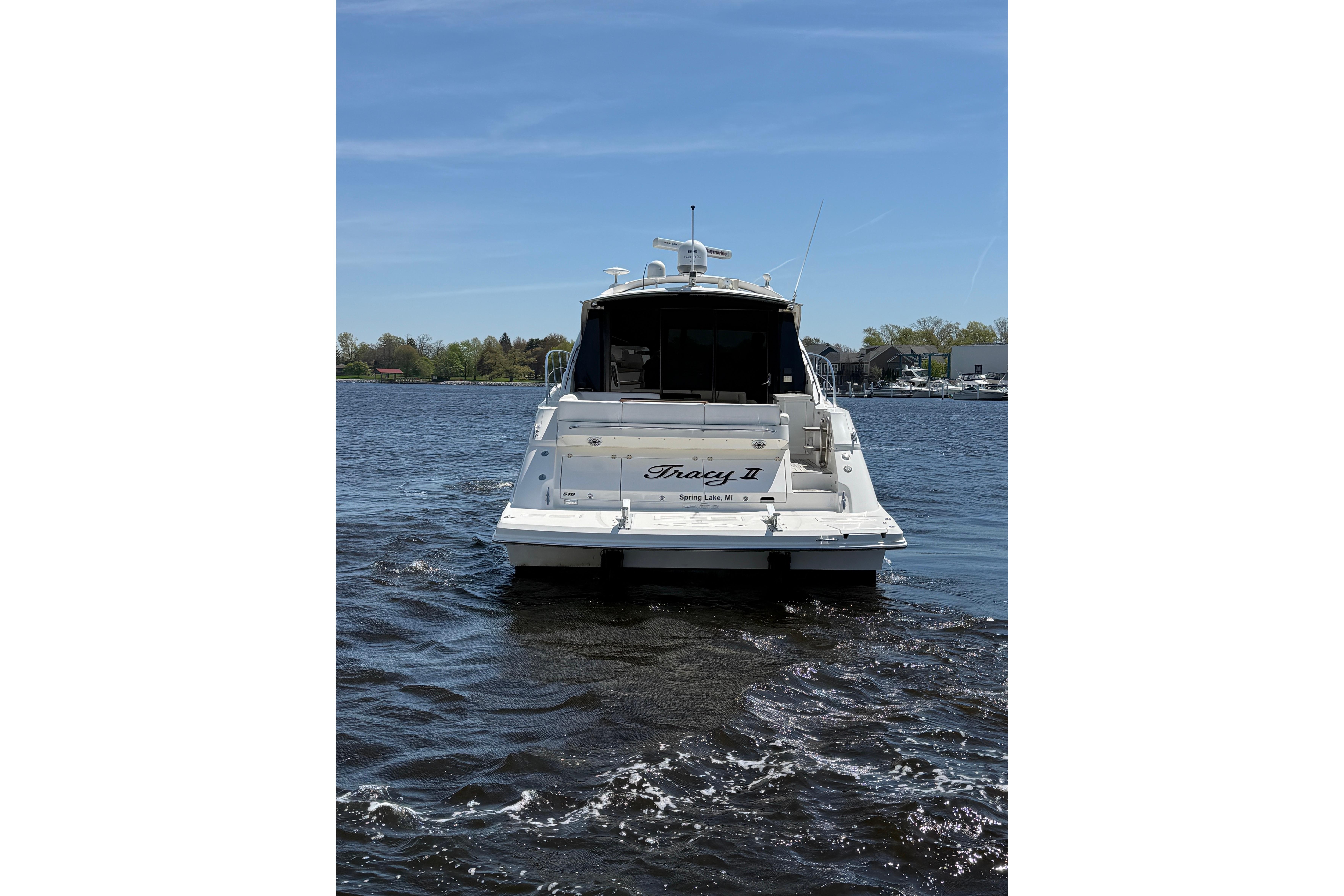 2014 Sea Ray Sundancer 510 yacht on calm water, rear view.
